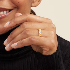 Close-up of a woman's hand wearing the PavÃ© Diamond Soft Charlotte Ring, featuring multiple diamonds set in 14k gold.