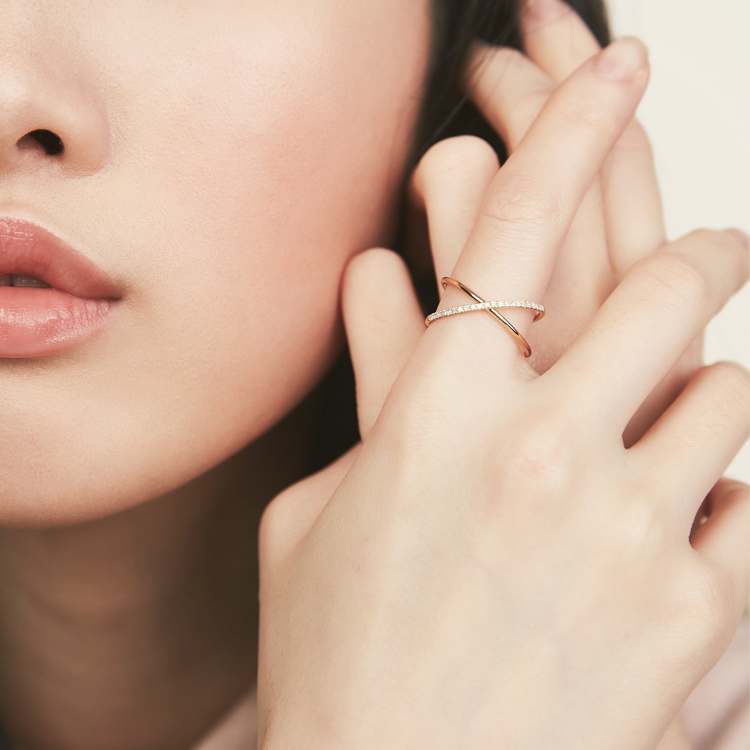 Close-up of a woman's hand wearing the PavÃ© Diamond X Ring, showcasing the intricate 14k gold band set with pavÃ© diamonds.