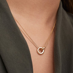 Person wearing Vermeil Linked Necklace featuring two interlinked rings, symbolizing strong personal bonds. Handcrafted in gold vermeil over 925 sterling silver.
