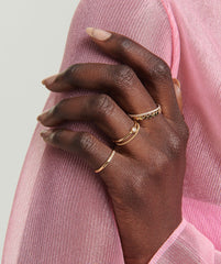 Close-up of a hand wearing the Dot Ring, showcasing gold stackable rings designed for everyday wear.