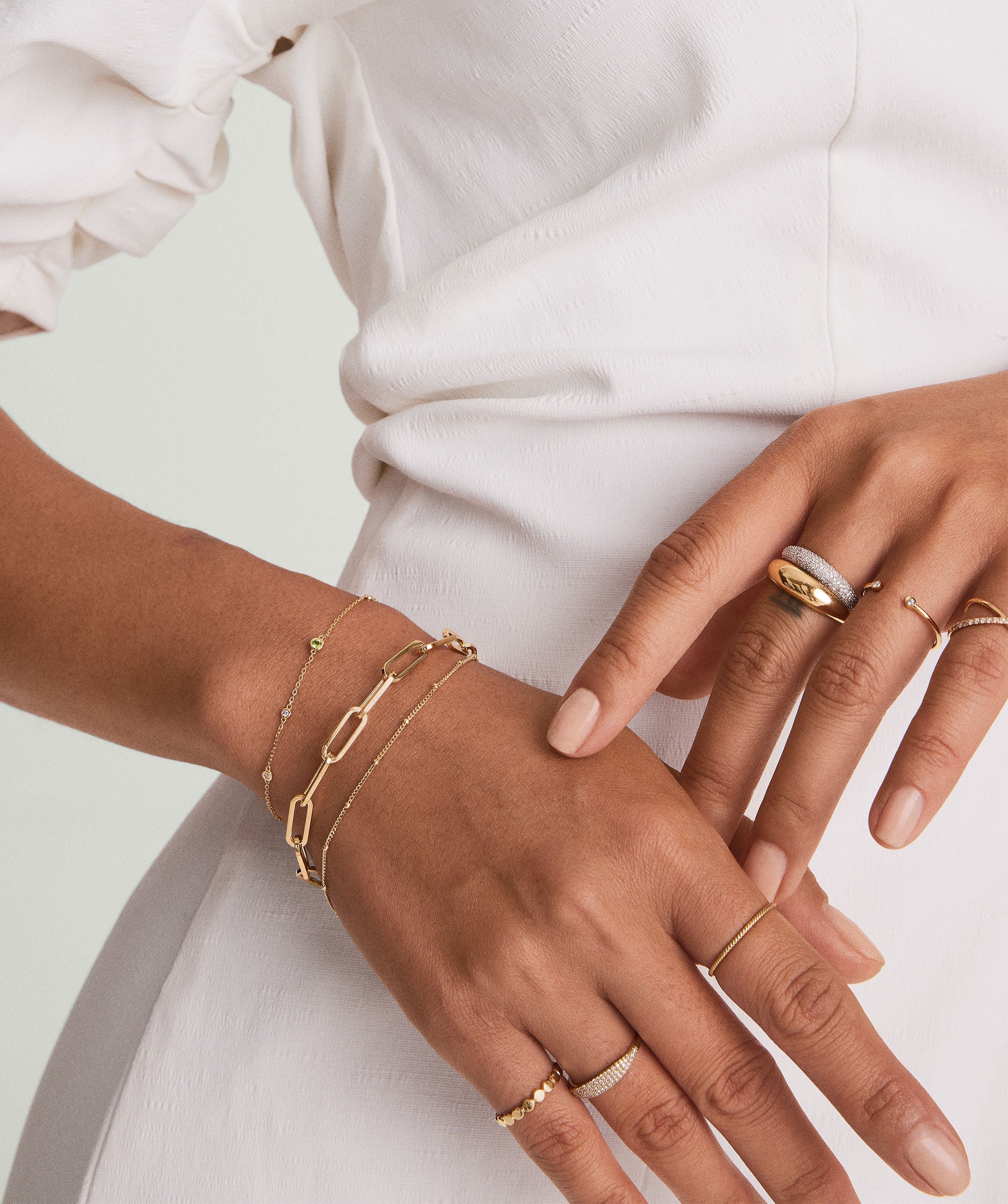 Close-up of a woman's hand wearing the PavÃ© Diamond Thin DÃ´me Ring, showcasing its intricate design and sparkling diamonds set in 14k solid gold.