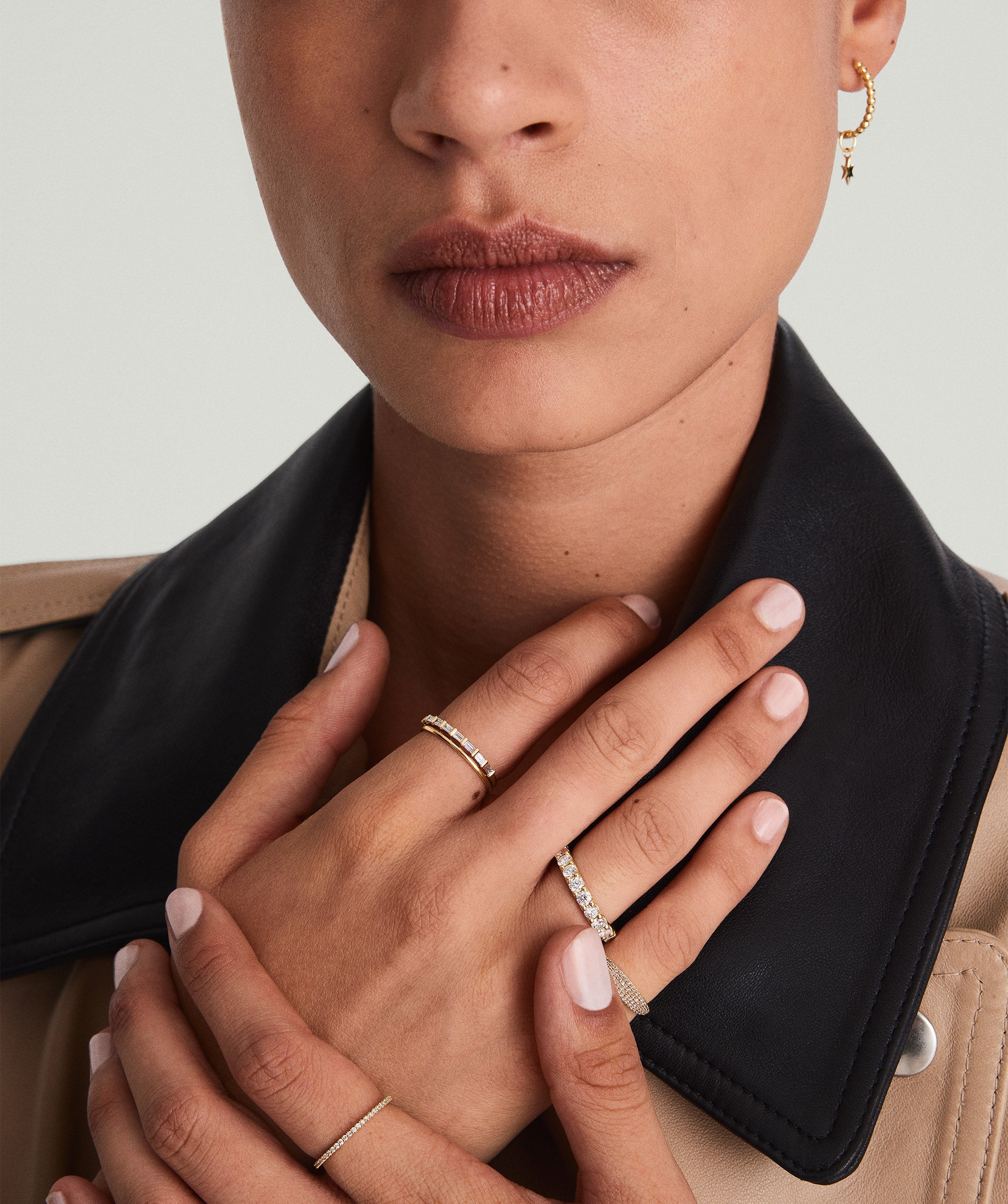 Bold Diamond Eternity Ring: Close-up of a woman's hand showcasing a 14k solid gold ring with 23 round brilliant cut diamonds, each set in open prongs.