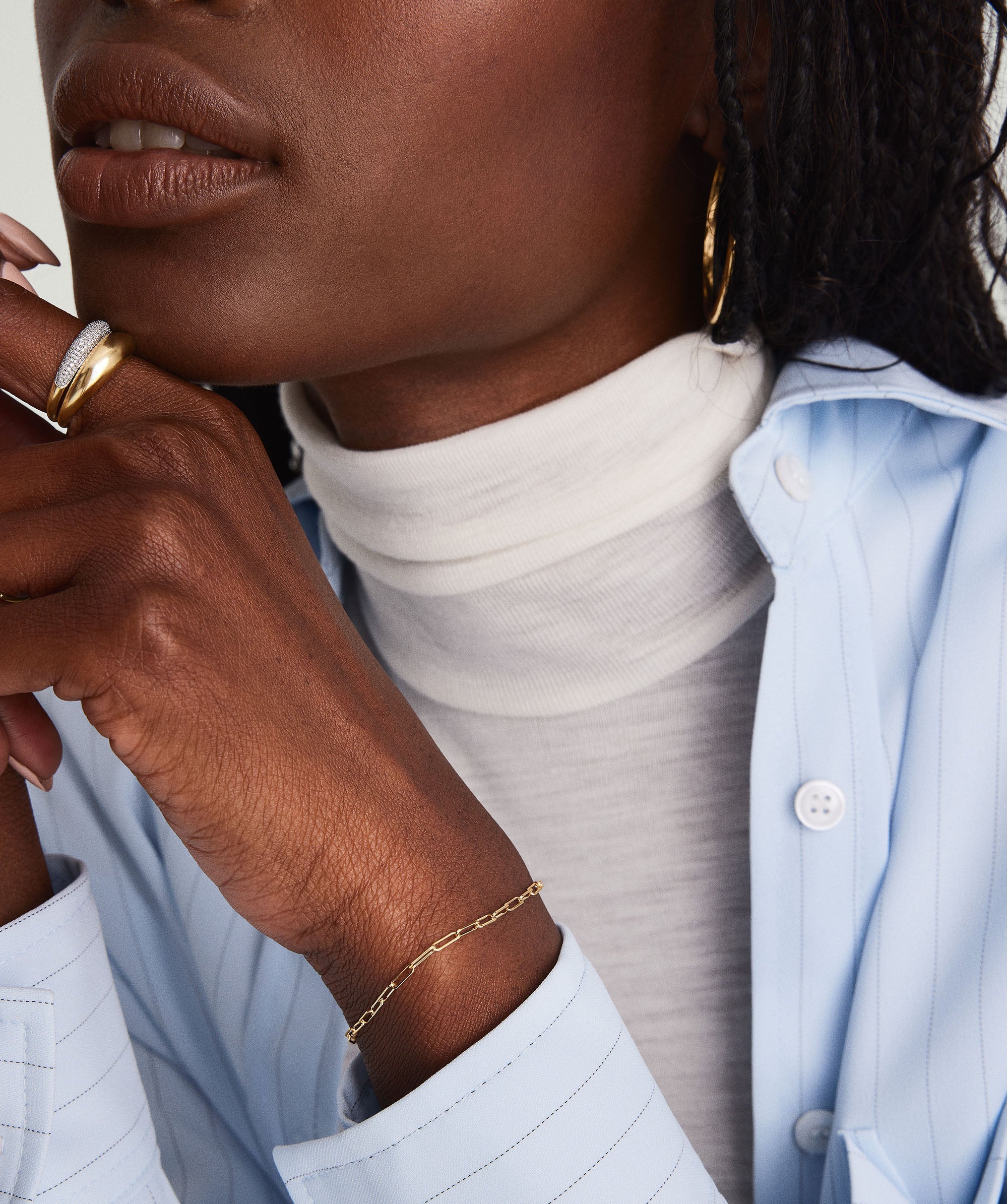 Close-up of a woman's hand wearing the Boyfriend Bold Bracelet, a handcrafted 14k solid gold piece, showcasing its raw, loose, and bold design.