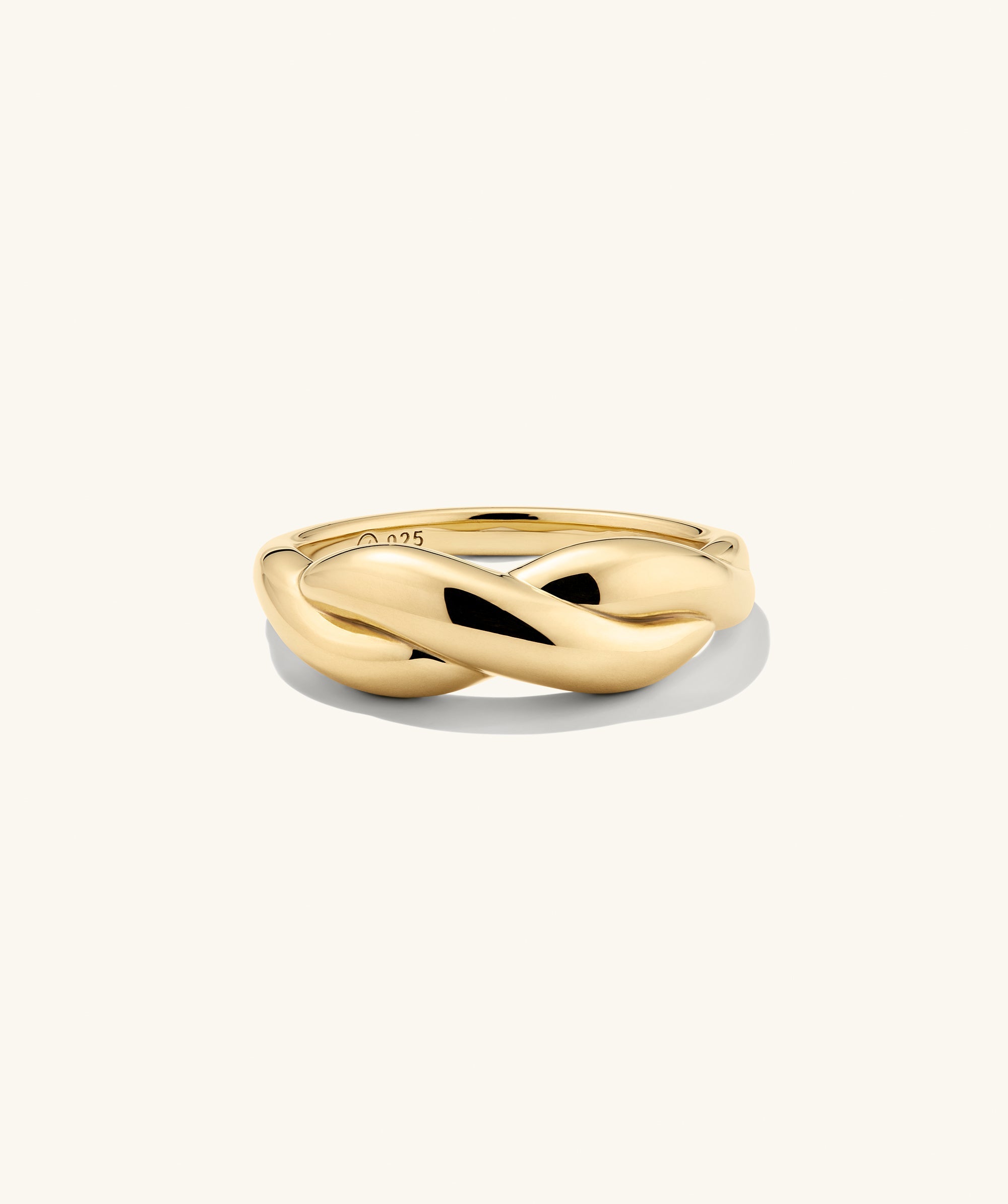 Brioche Ring with a polished, twisted infinity design, showcasing a simple yet elegant style perfect for stacking and everyday wear.