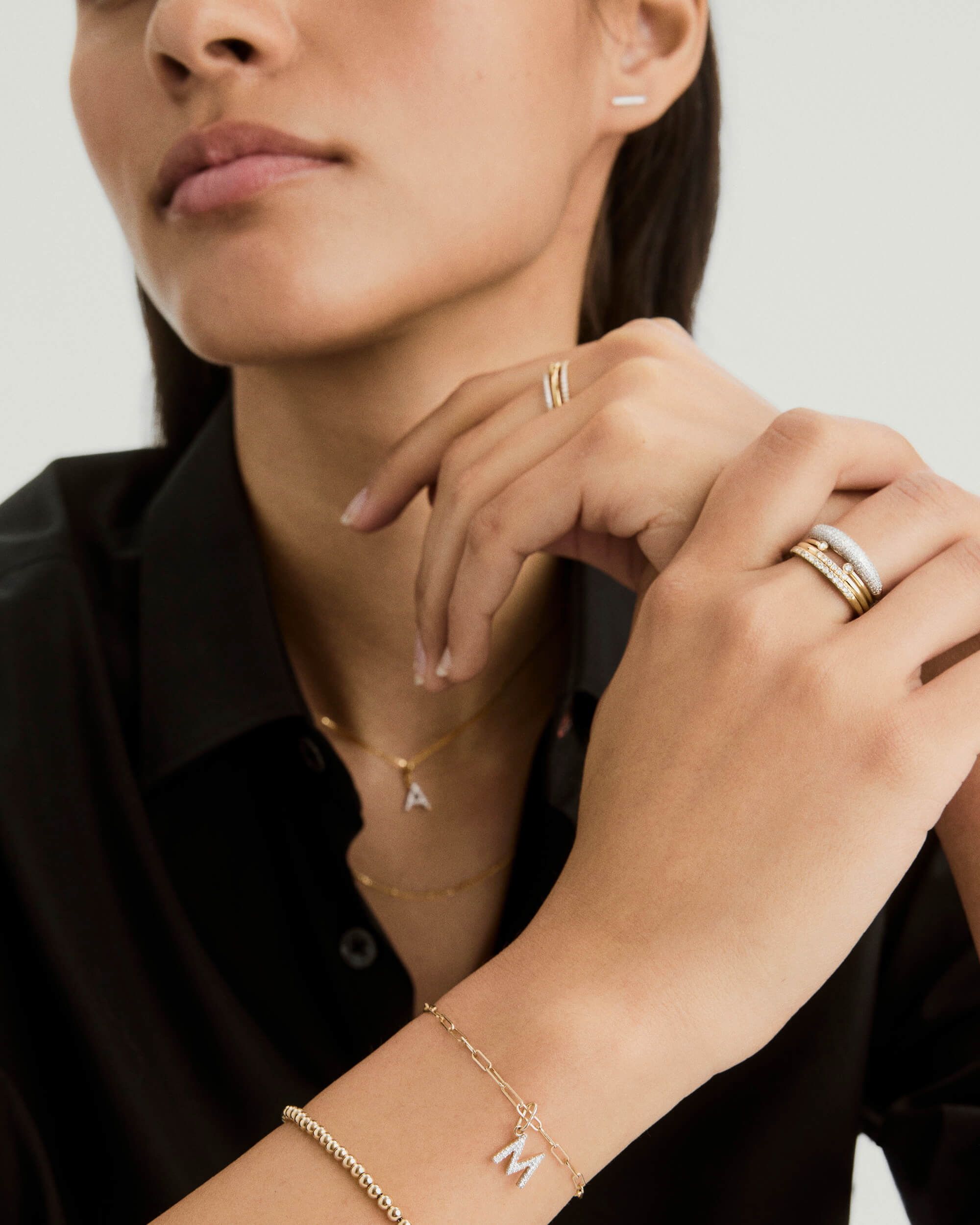 Diamond Letter Charm displayed on a woman's gold chain necklace, highlighting elegant fashion accessory details. Perfect for customizing with your initials.