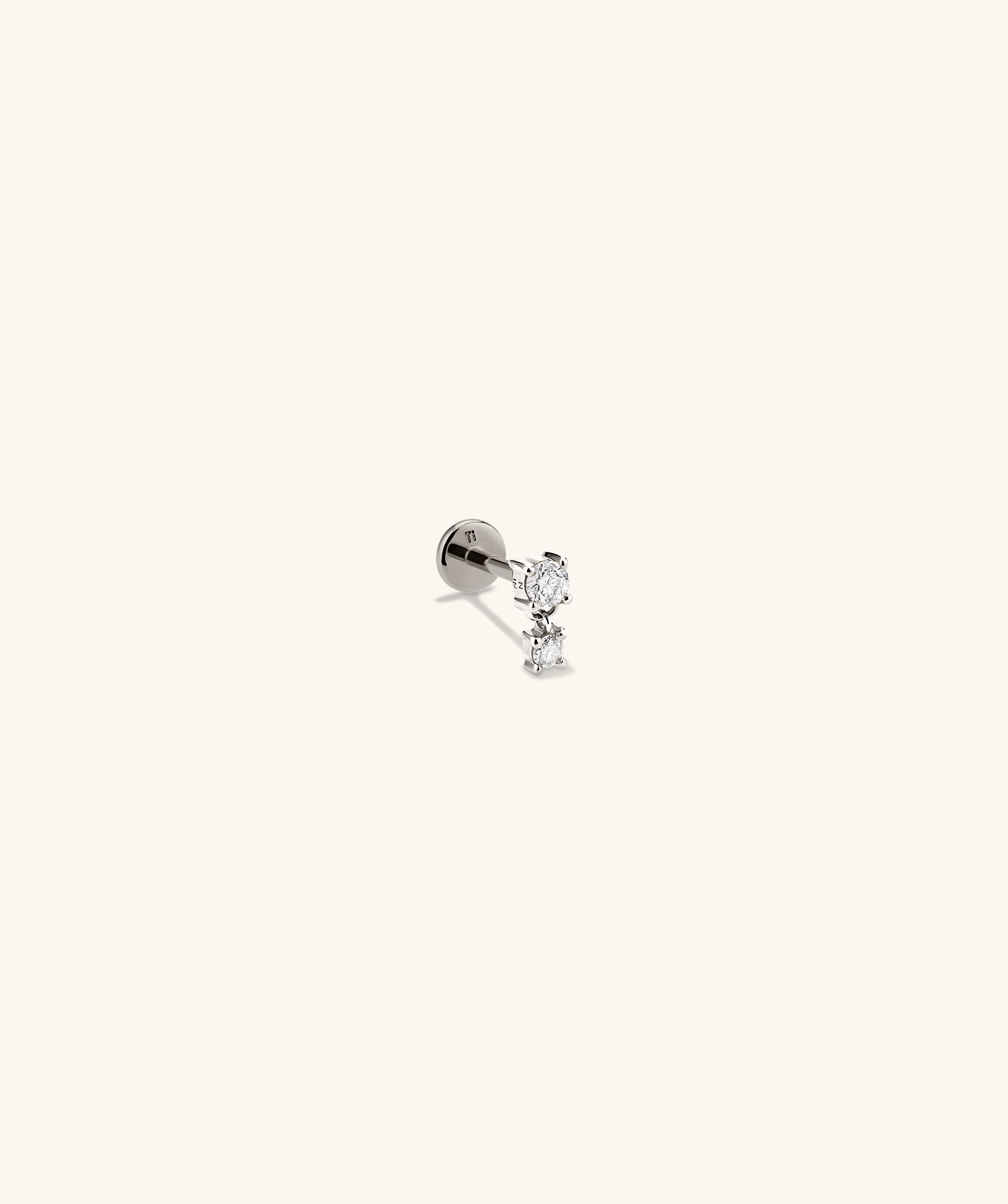 Diamond Droplet Stud earring, silver with diamond accents, showcased in a detailed close-up, highlighting its intricate design and elegant craftsmanship.