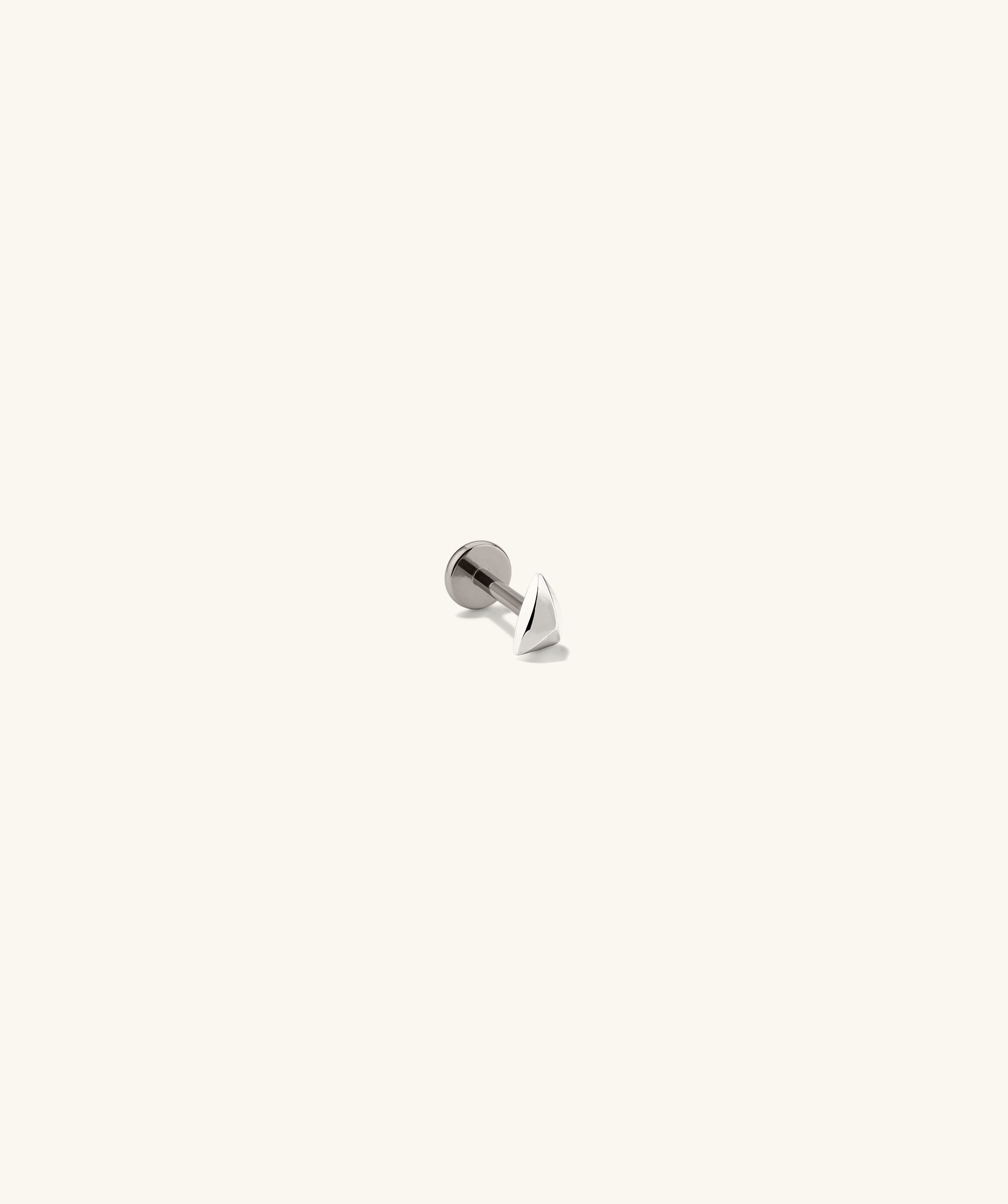 Close-up of the Piercing Studio - Puffy Pyramid Flat Back Stud, showcasing its sleek, metallic pyramid design, emphasizing a softer, rounded shape for stylish adornment.