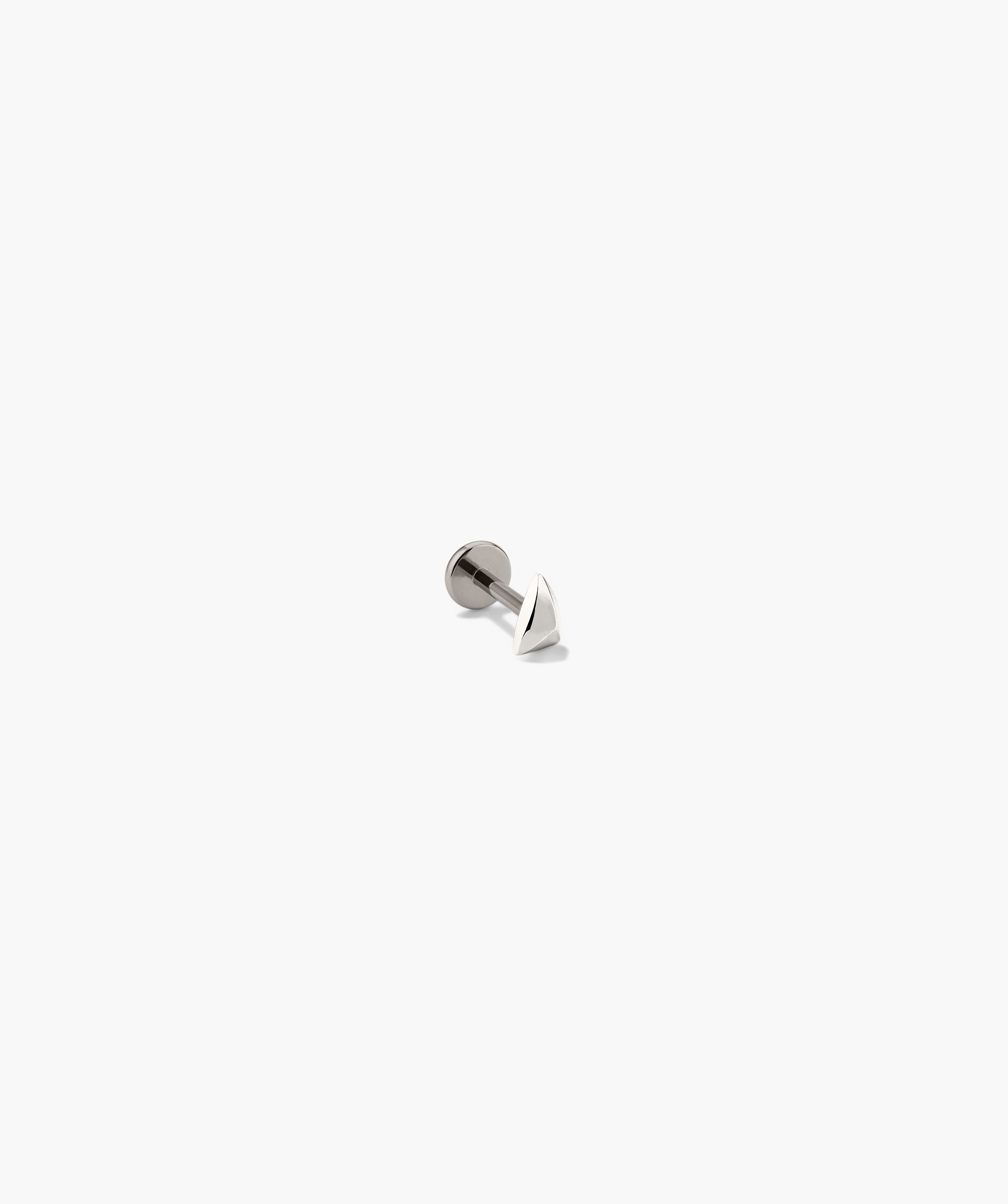 Close-up of the Piercing Studio - Puffy Pyramid Flat Back Stud, showcasing its sleek, metallic pyramid design, emphasizing a softer, rounded shape for stylish adornment.