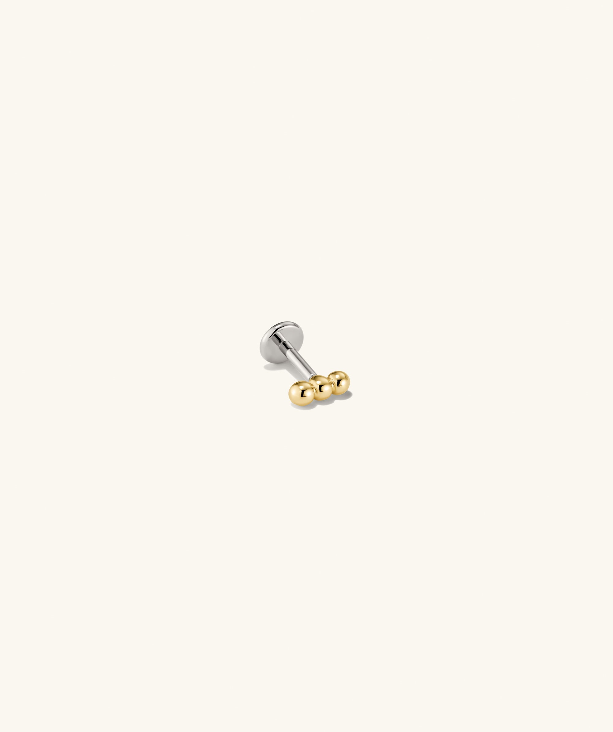 Spheres Bar Stud earring featuring a silver and gold design with three spherical elements forming a bar, ideal for versatile stacking.