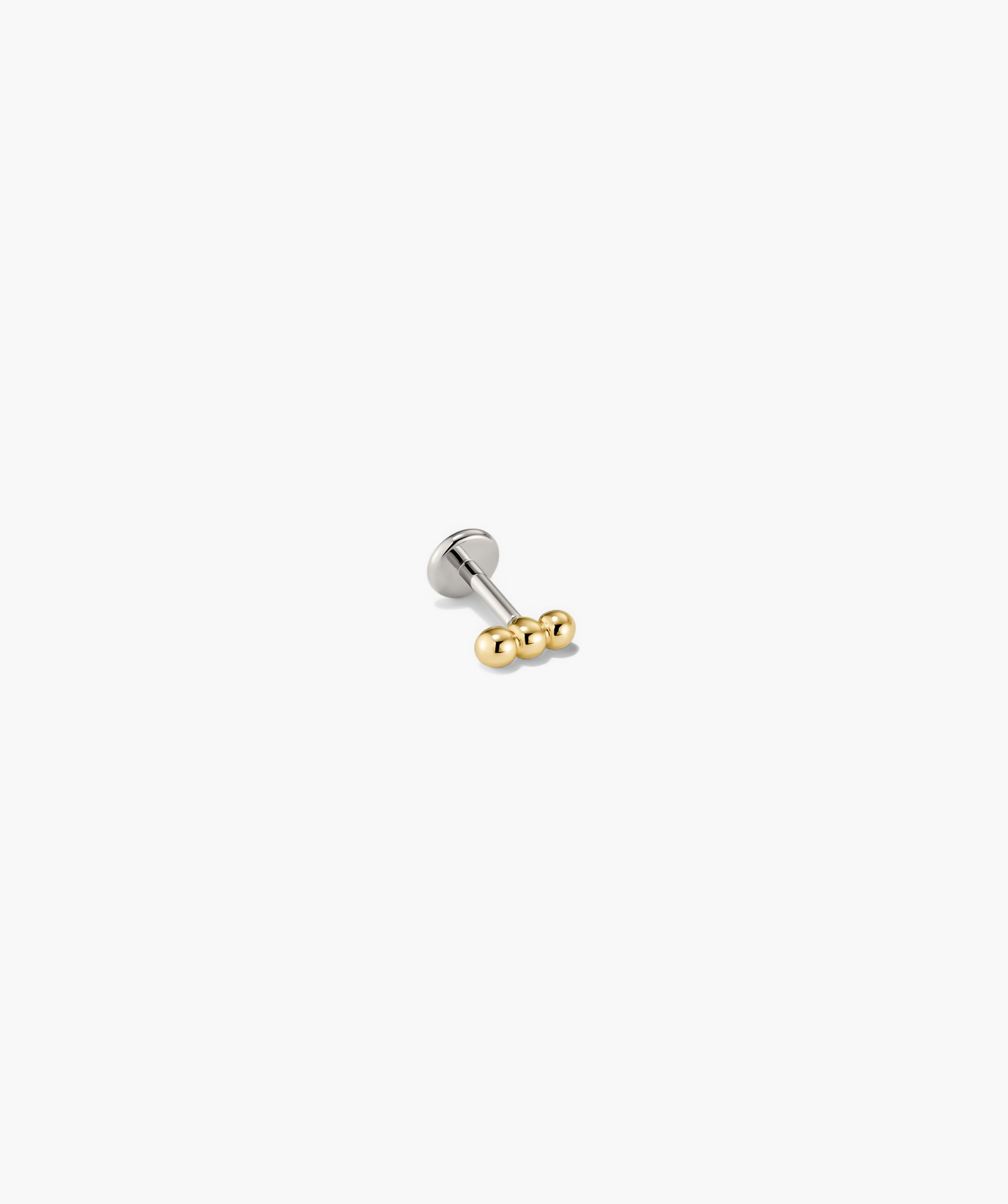 Spheres Bar Stud earring featuring a silver and gold design with three spherical elements forming a bar, ideal for versatile stacking.