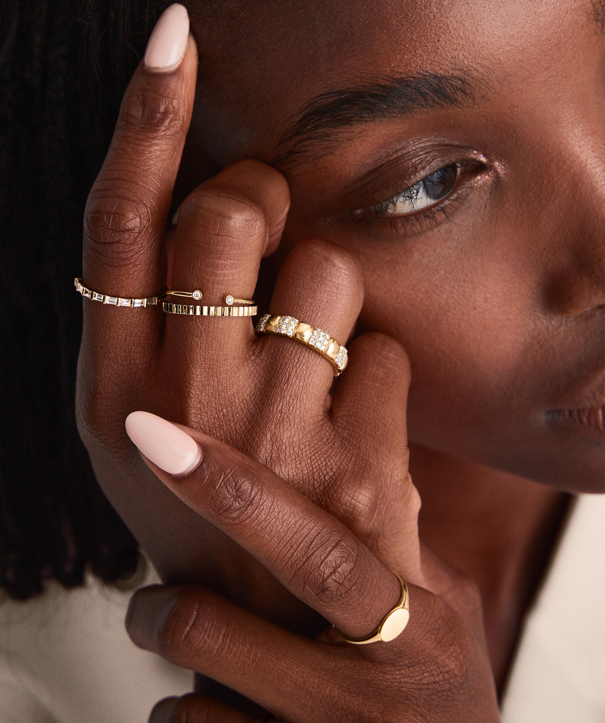 Close-up of a woman showcasing the handcrafted 14k gold Eternity Line Band on her finger, highlighting its intricate design and elegance.