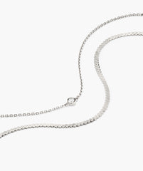 Double Take Bracelet Bundle featuring a fine link chain with a bezel-set clear stone and a wider snake-style chain, both in a delicate silver tone.