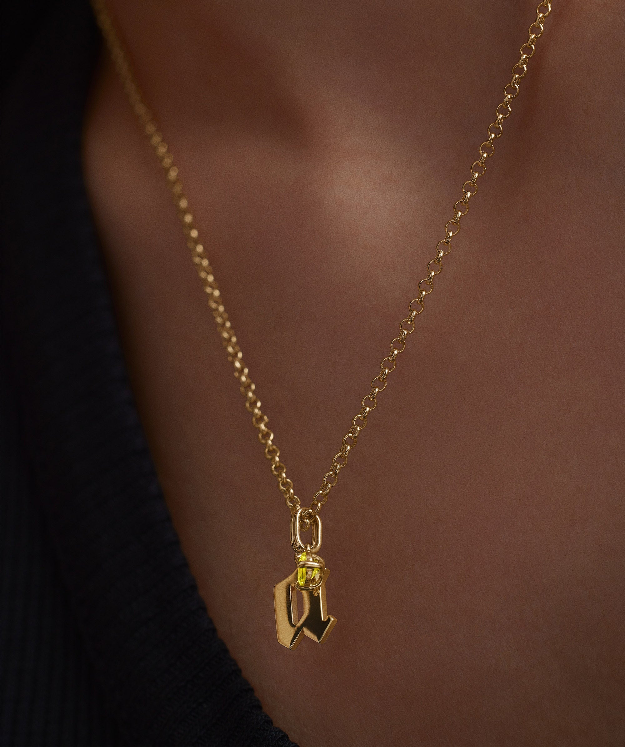 Close-up of a Baby Rolo Chain necklace, featuring a delicate gold chain with a subtle yellow gem pendant, ideal for everyday wear.