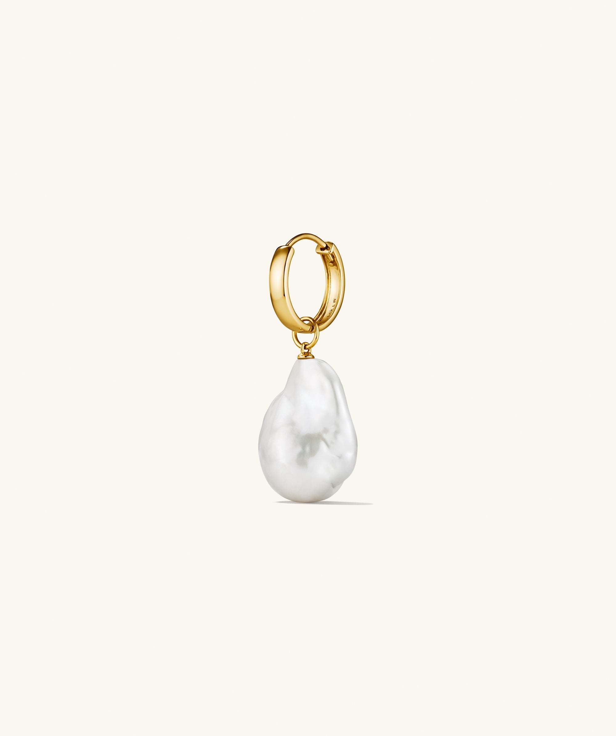 Oversized Baroque Pearl Hoop Charm featuring an irregular, sculptural pearl suspended from a sleek gold hoop, ideal for pairing with various earrings for a statement look.