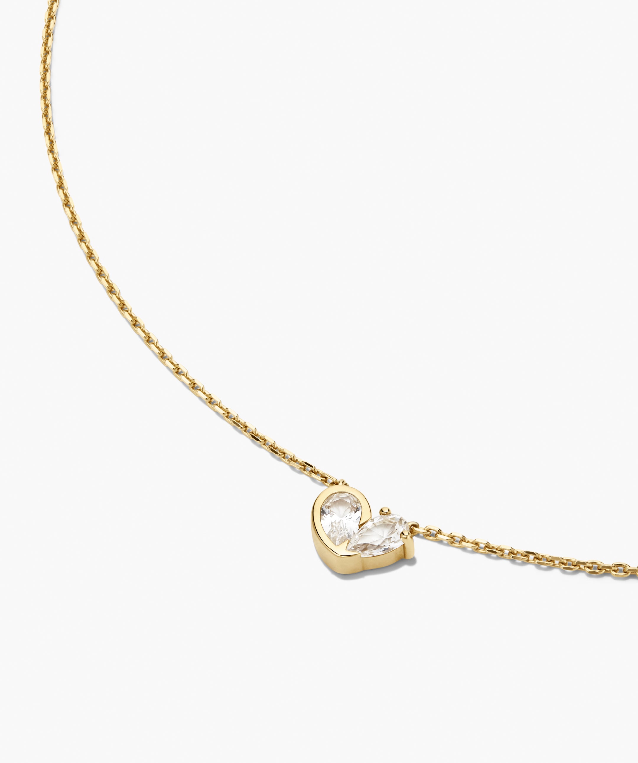 Two of Hearts Necklace: A delicate gold chain with a heart-like pendant of two pear-cut stones, blending bezel and prong settings for elegant layering.