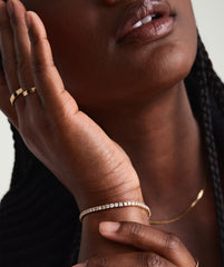 Close-up of a woman wearing a Lab Grown Diamond Tennis Bracelet 2.5mm, showcasing its sparkle and elegant fit on her wrist.