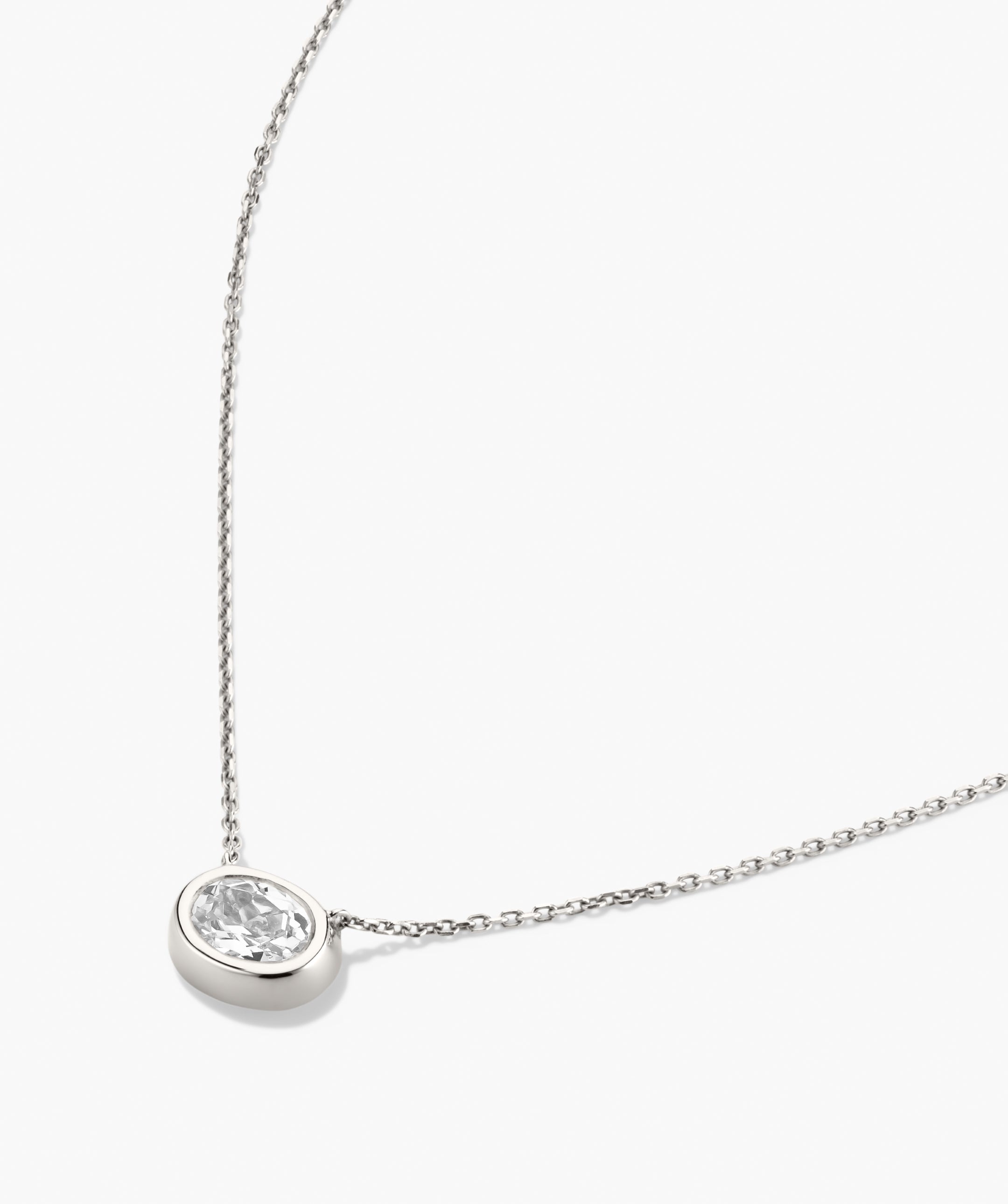 Lucia Necklace: A delicate chain featuring an oval bezel-set lab grown sapphire pendant, designed to be the centerpiece of any ensemble.