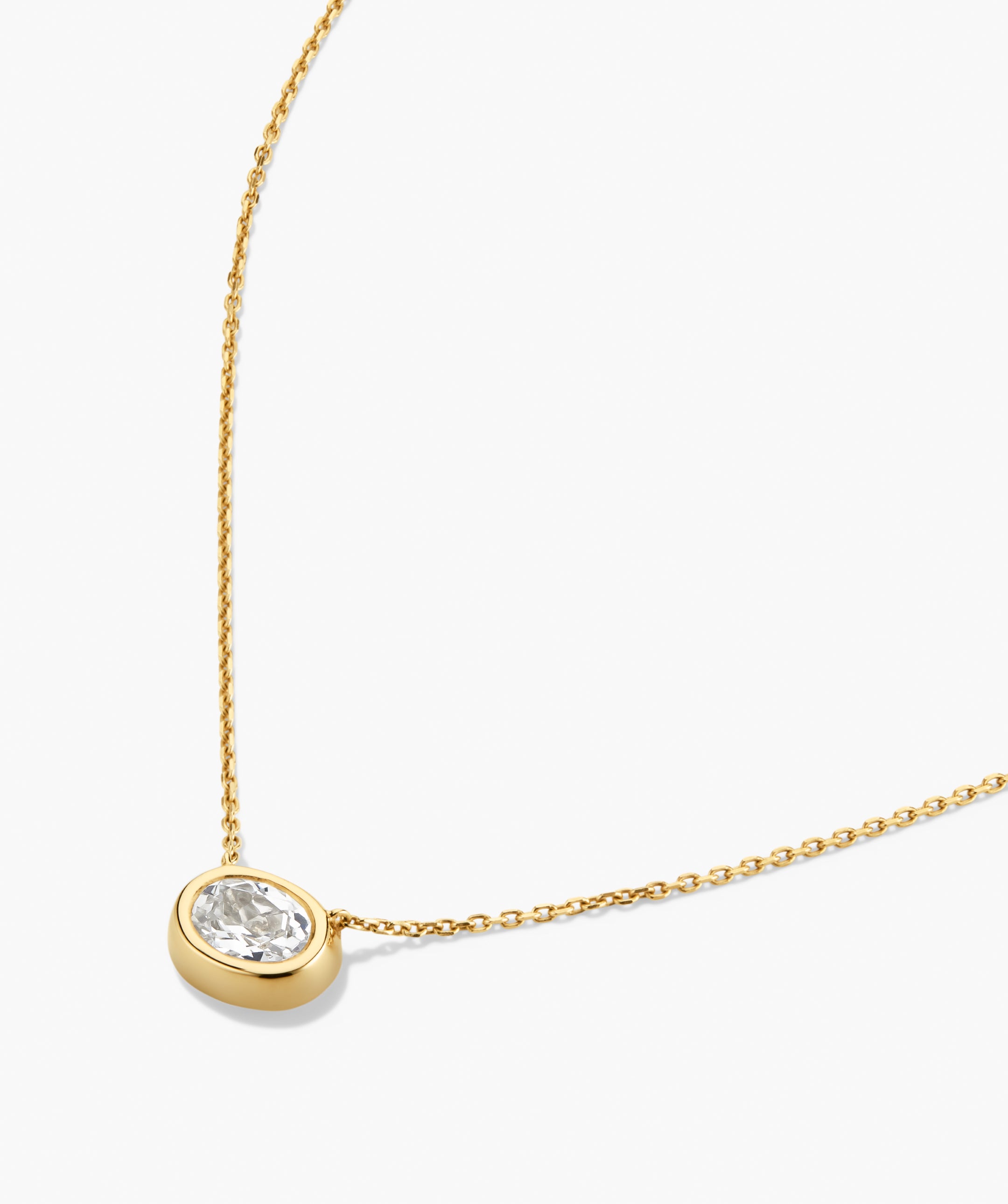 Lucia Necklace: A minimalist gold chain with an oval bezel-set lab-grown sapphire pendant, exemplifying a signature piece for any look.