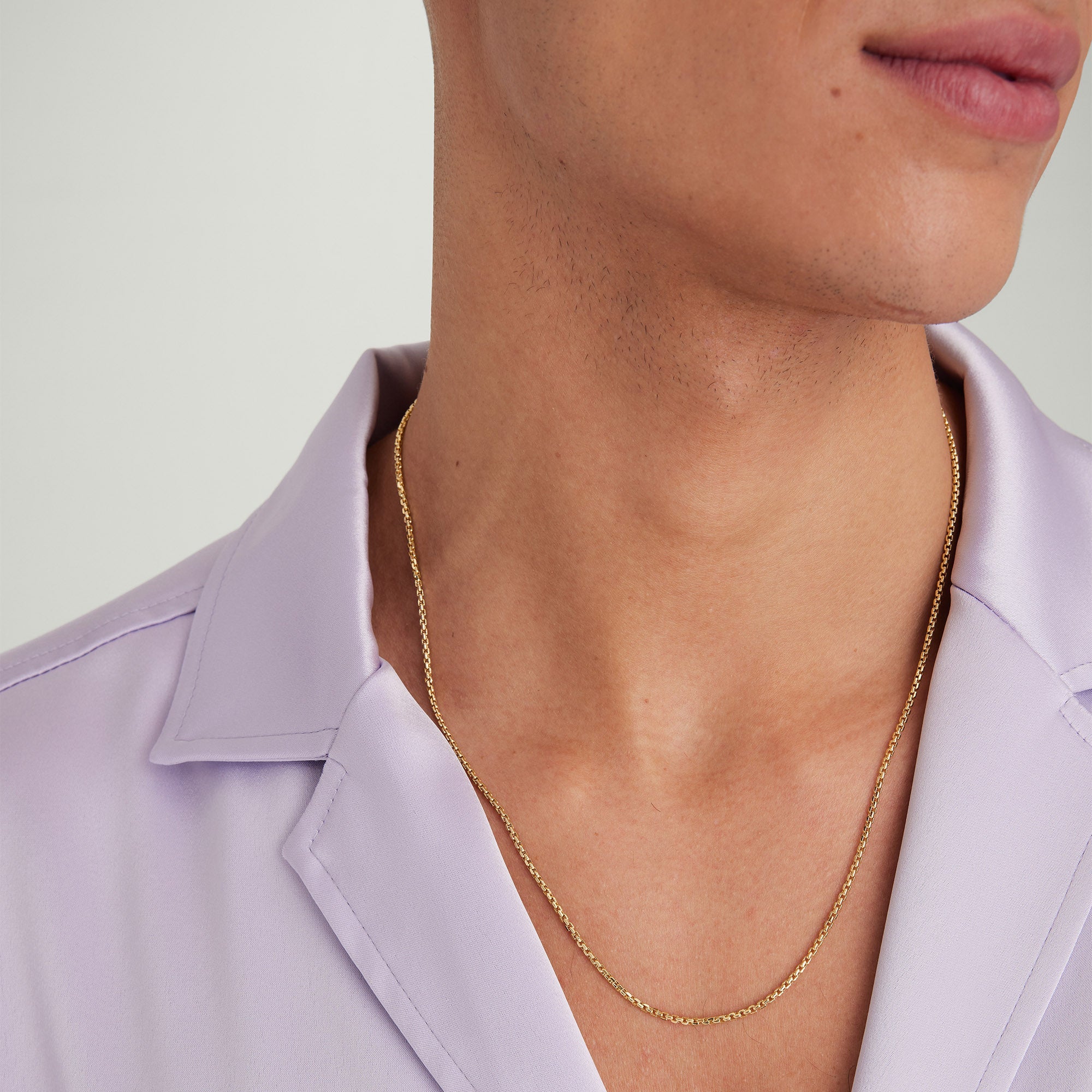 Person wearing the Round Box Chain Necklace, a simple yet elegant gold chain suited for everyday wear, complementing the Round Box Chain Bracelet.