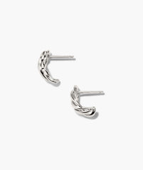 Bold Open DÃ´me Huggies featuring silver-tone, twisted hoop design with textured, intertwined rope appearance; asymmetrical, eye-catching, and understated earrings with short posts for piercing.