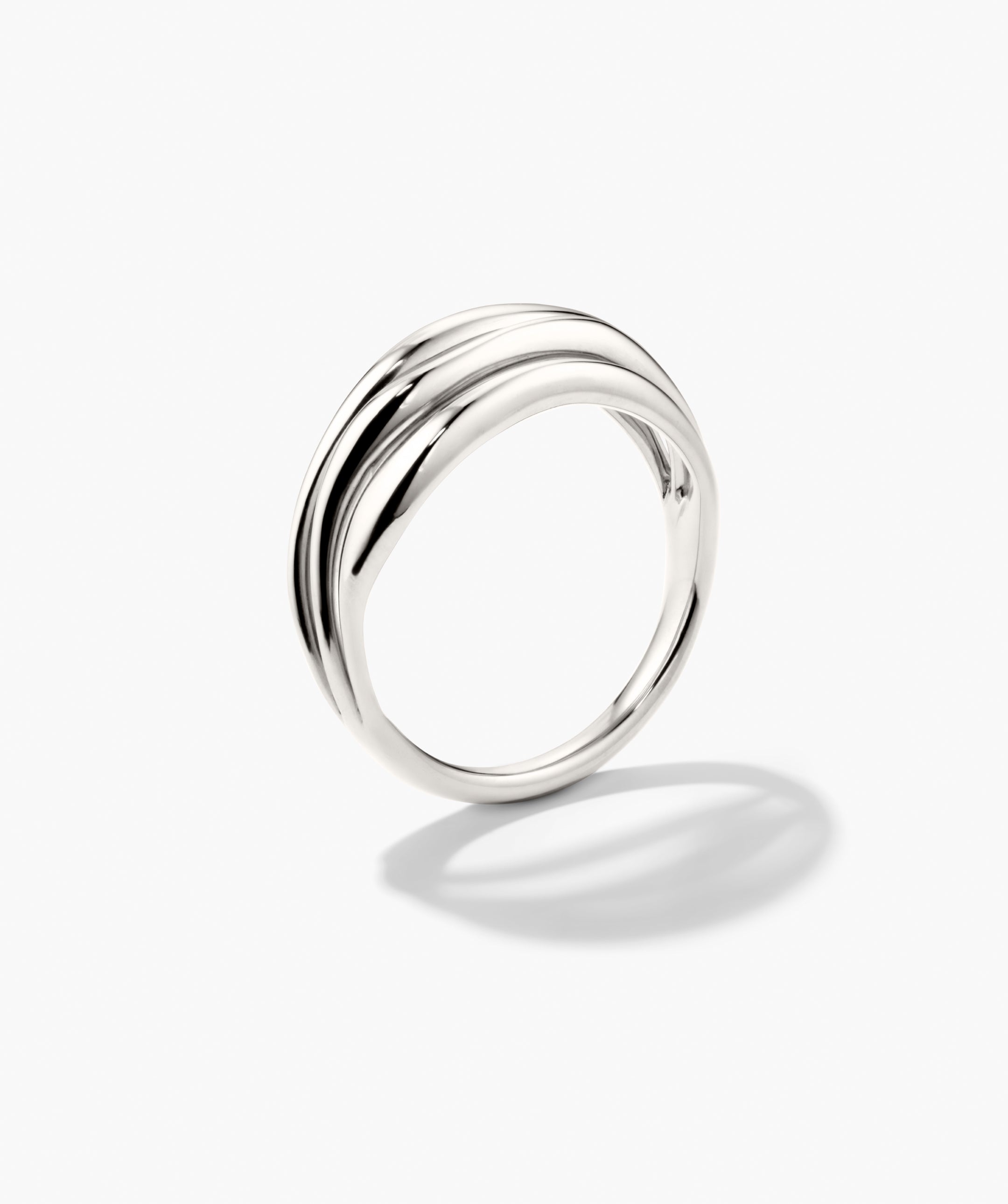 Bold Open DÃ´me Ring: A polished silver band with subtle wave detail, embodying open spaces and asymmetrical design for a striking yet minimalist statement.