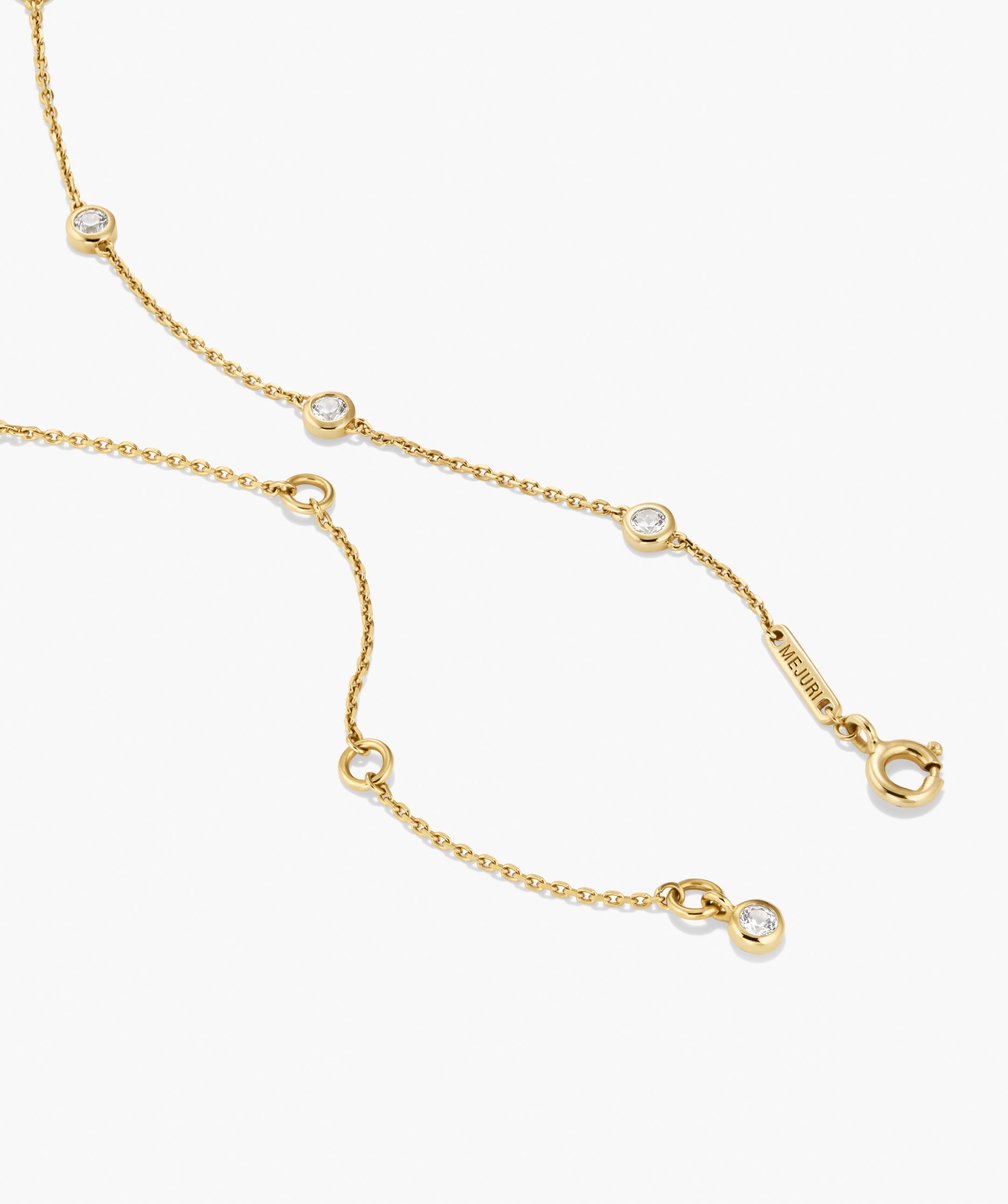 Lab Grown Sapphire Orbit Necklace with five round bezel-set stones on a delicate chain, featuring a spring-ring clasp and MEJURI tag.