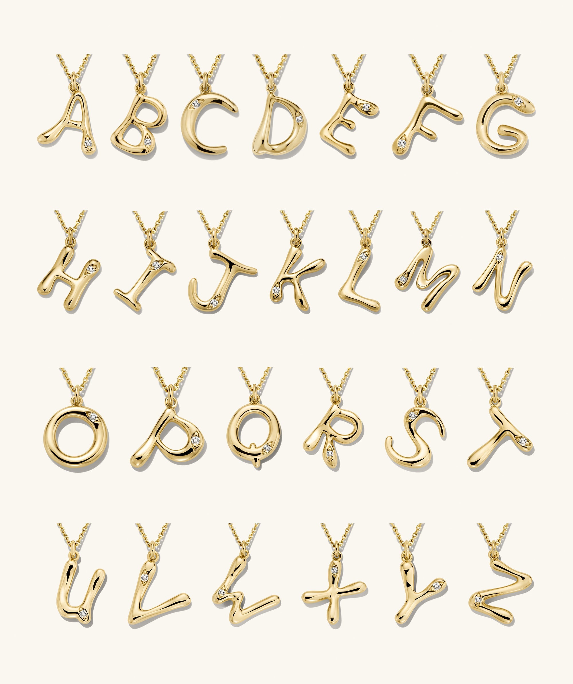 Organic DÃ´me Liquid Letter Pendant Necklace with unique gold letters and gemstones, showcasing a personalized, organic design.