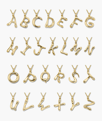 Organic DÃ´me Liquid Letter Pendant Necklace with unique gold letters and gemstones, showcasing a personalized, organic design.