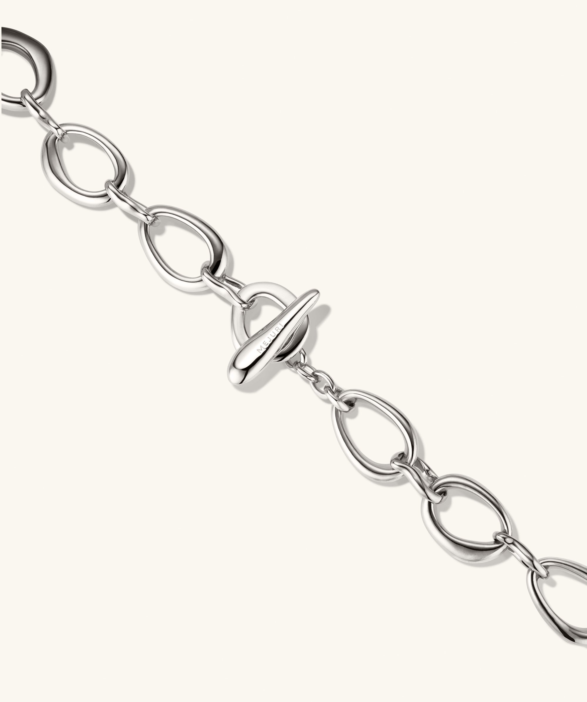 Organic DÃ´me Ripple Chain Necklace featuring organic, irregular silver links and a toggle clasp, highlighting its elegant and fluid design.