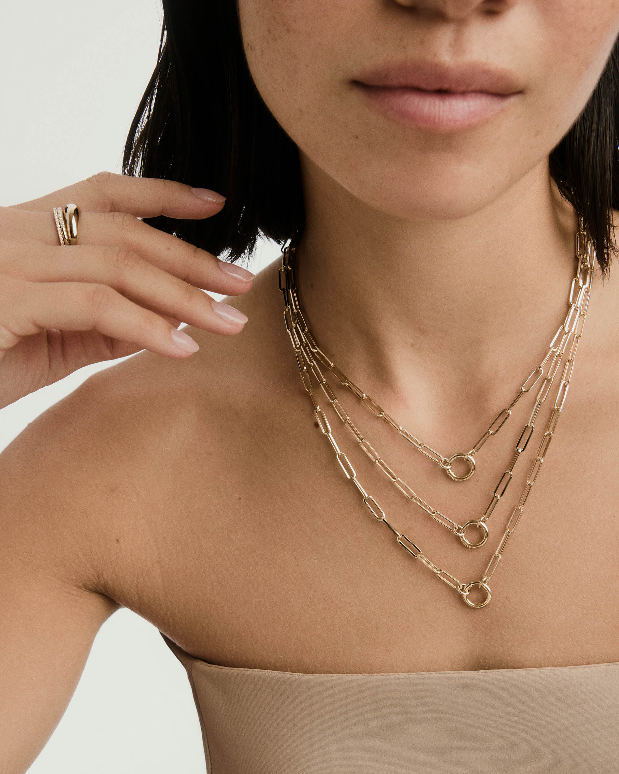 Woman wearing Paperclip Chain Charm Necklace featuring bold chain and Stacker Clasp, designed for layering charms, handcrafted in 14k recycled solid gold.