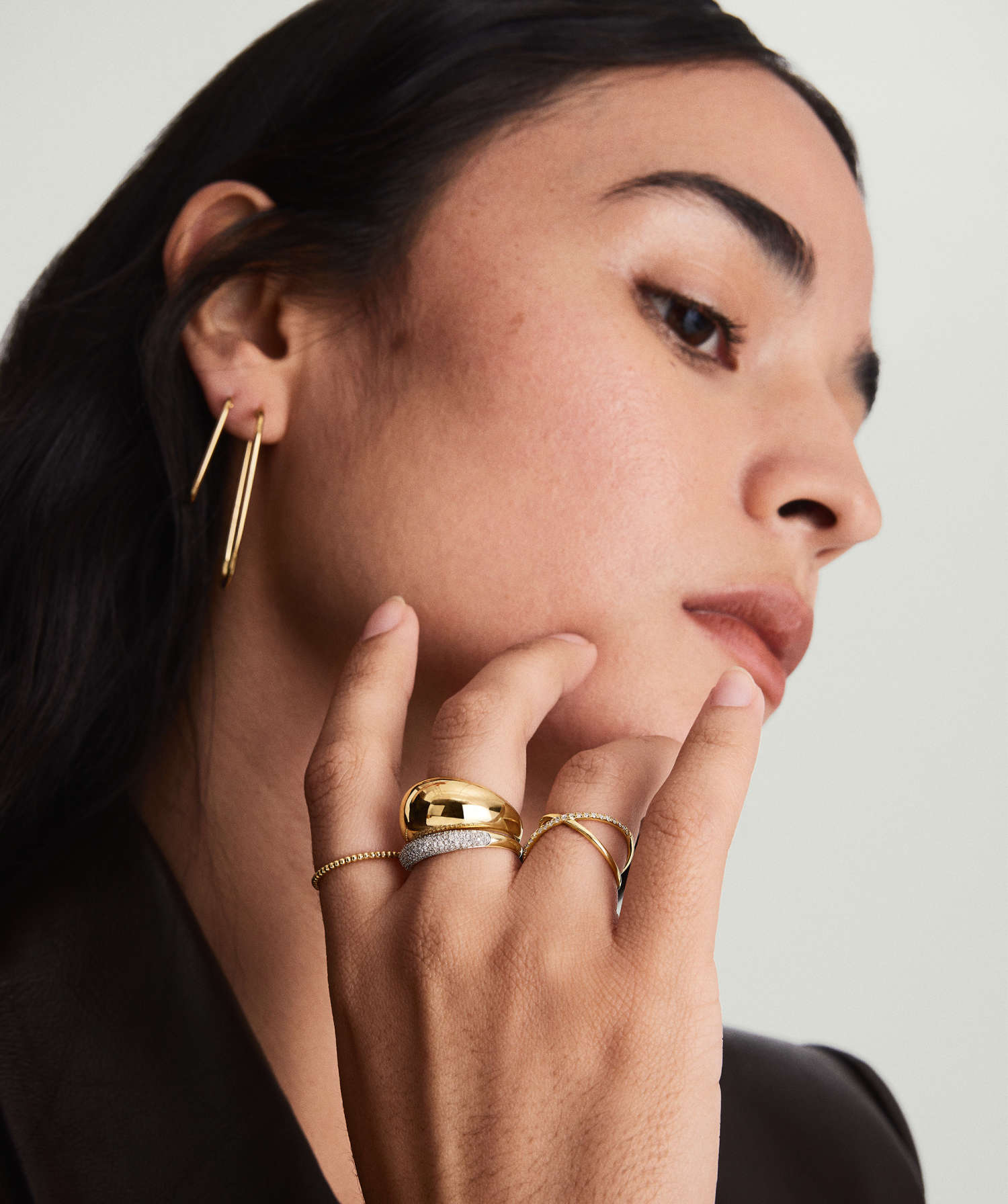 Close-up of a woman's hand showcasing the PavÃ© Diamond Thin DÃ´me Ring, handcrafted in 14k solid gold with responsibly sourced diamonds, exuding elegance and sophistication.