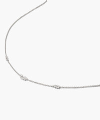 Floating Lab Grown Sapphire Necklace featuring a delicate silver chain with sparkling stones at intervals, elegantly displayed against a white background.