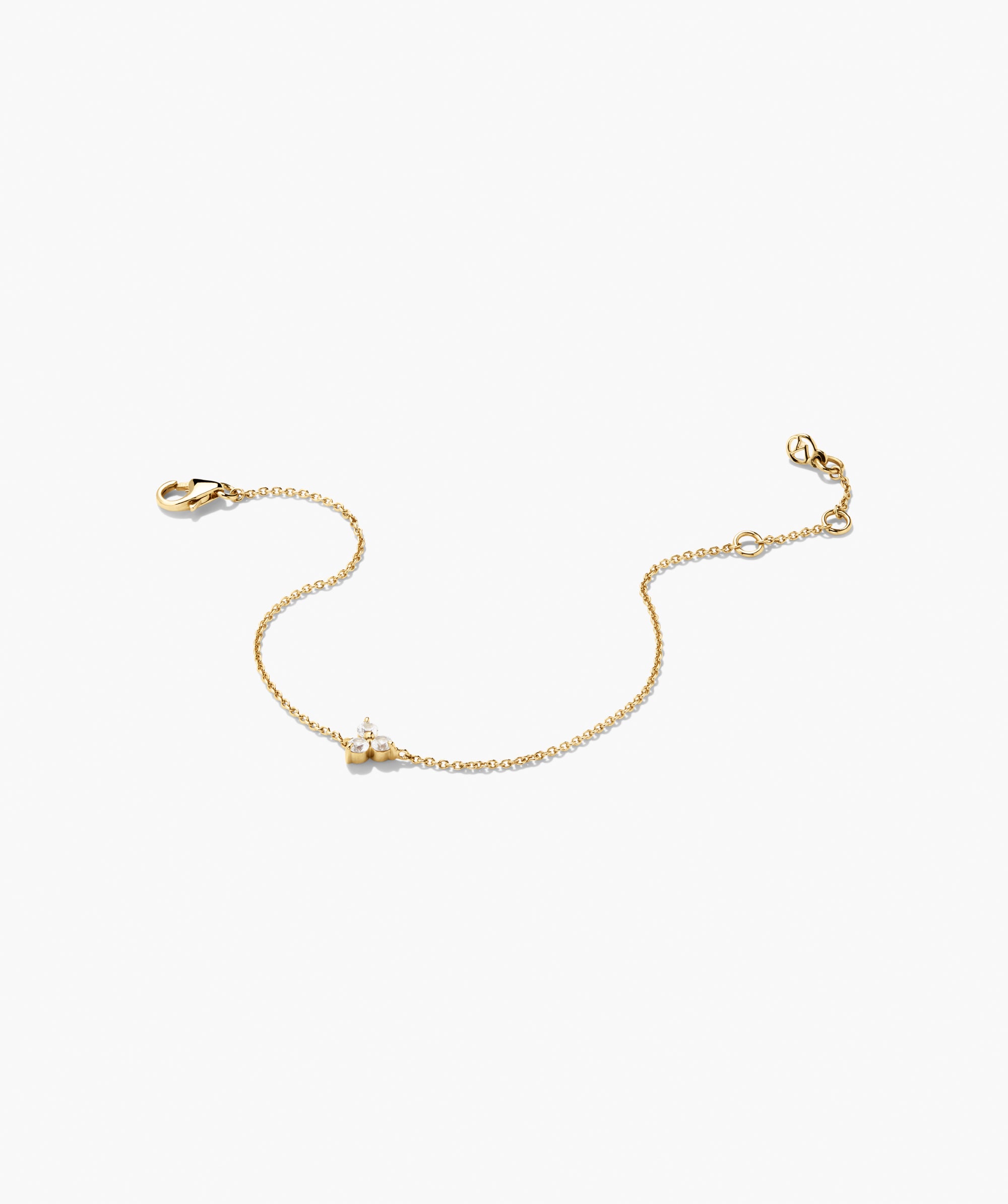 Lotus Bracelet featuring a yellow-gold chain with a clover-shaped motif, set with three sparkling stones, and adjustable lobster clasp. Versatile for any occasion.