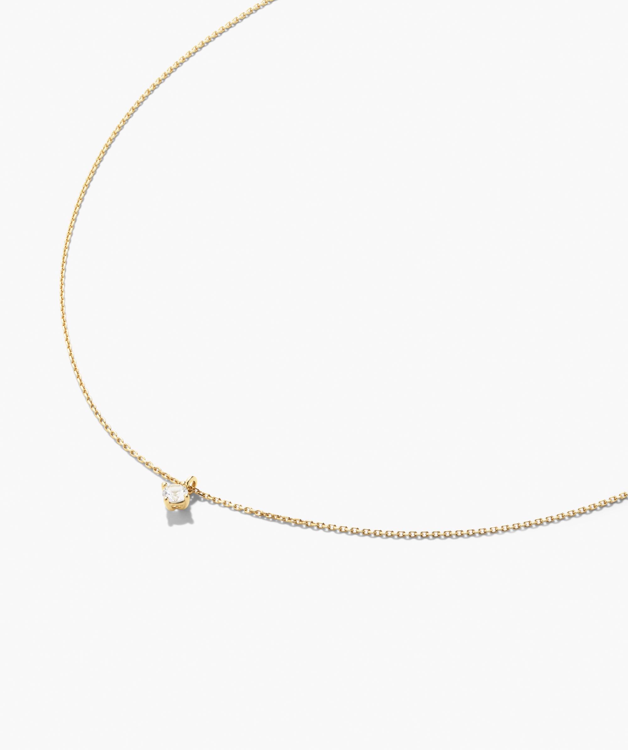 Round Lab Grown Sapphire Necklace featuring a delicate gold chain with a single brilliant-cut diamond in a four-prong setting, offering a minimalist elegance.