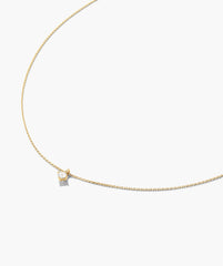 Round Lab Grown Sapphire Necklace featuring a delicate gold chain with a single brilliant-cut diamond in a four-prong setting, offering a minimalist elegance.