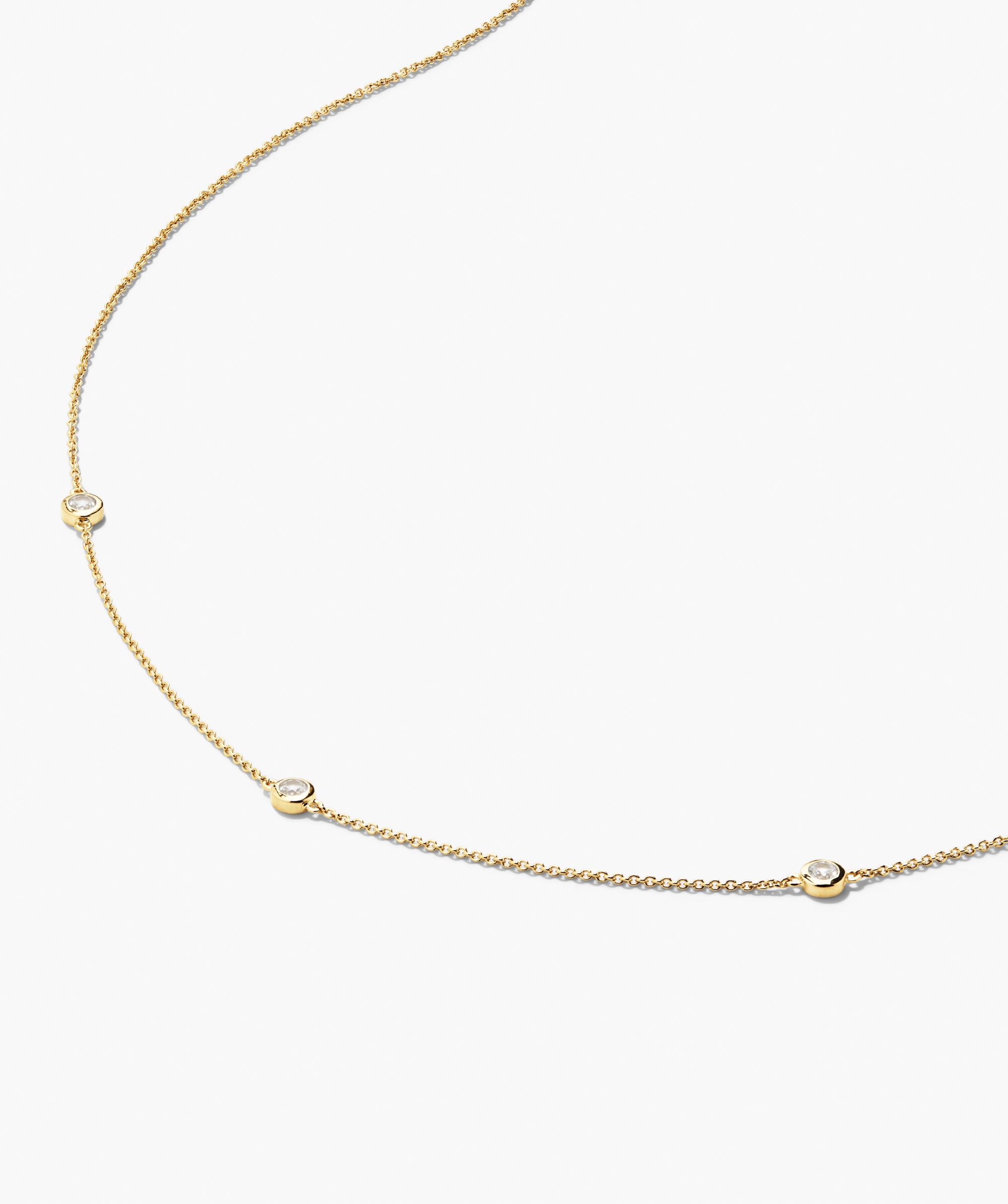 Satellite Necklace: A fine yellow-gold chain with three evenly spaced bezel-set white sapphires, crafted in vermeil, perfect for casual or formal wear.
