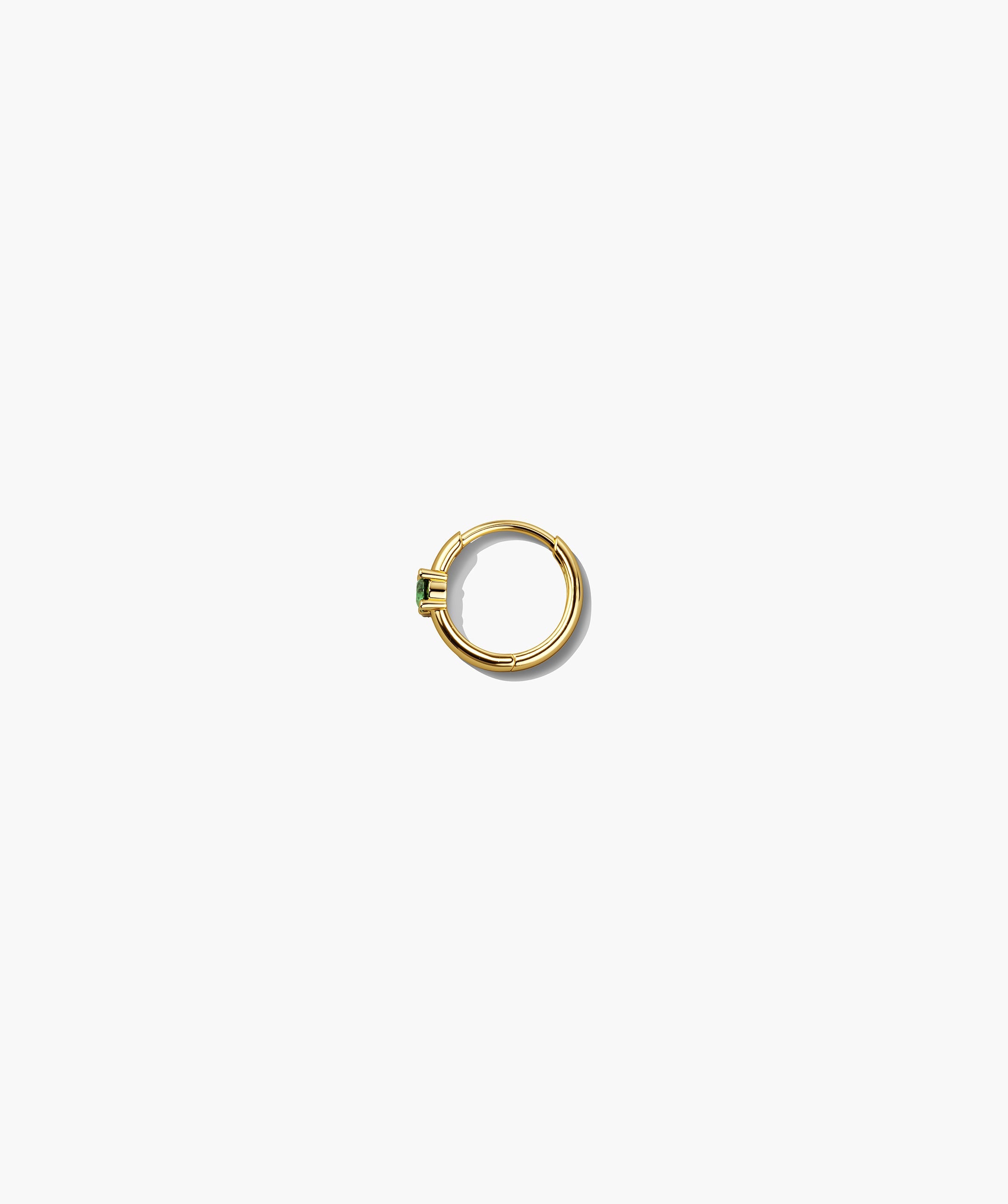 Single Colored Mini Hoop: A thin gold hoop earring with a hinge clasp, featuring a rectangular green stone in a prong setting. Sold individually.