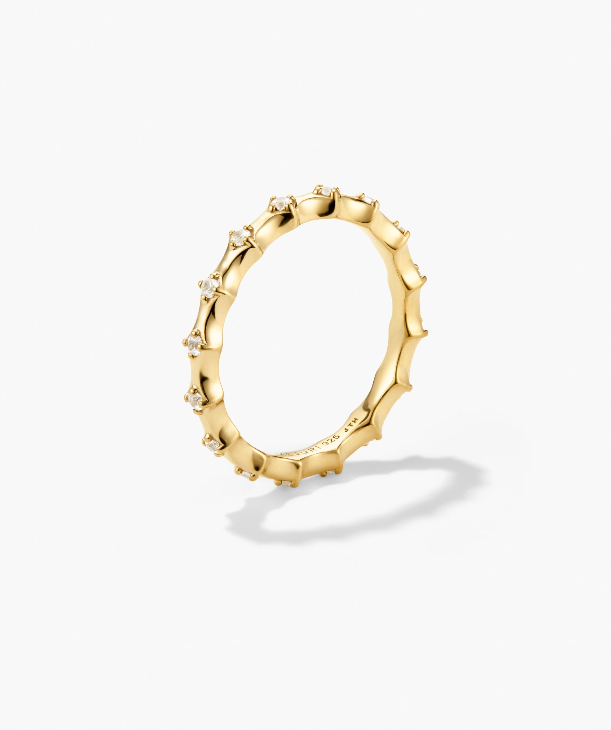 Charlotte Crest Stacker Ring with bamboo-textured gold band, prong-set white stones, and engraved interior, ideal for stacking with curved edges and delicate sapphires.