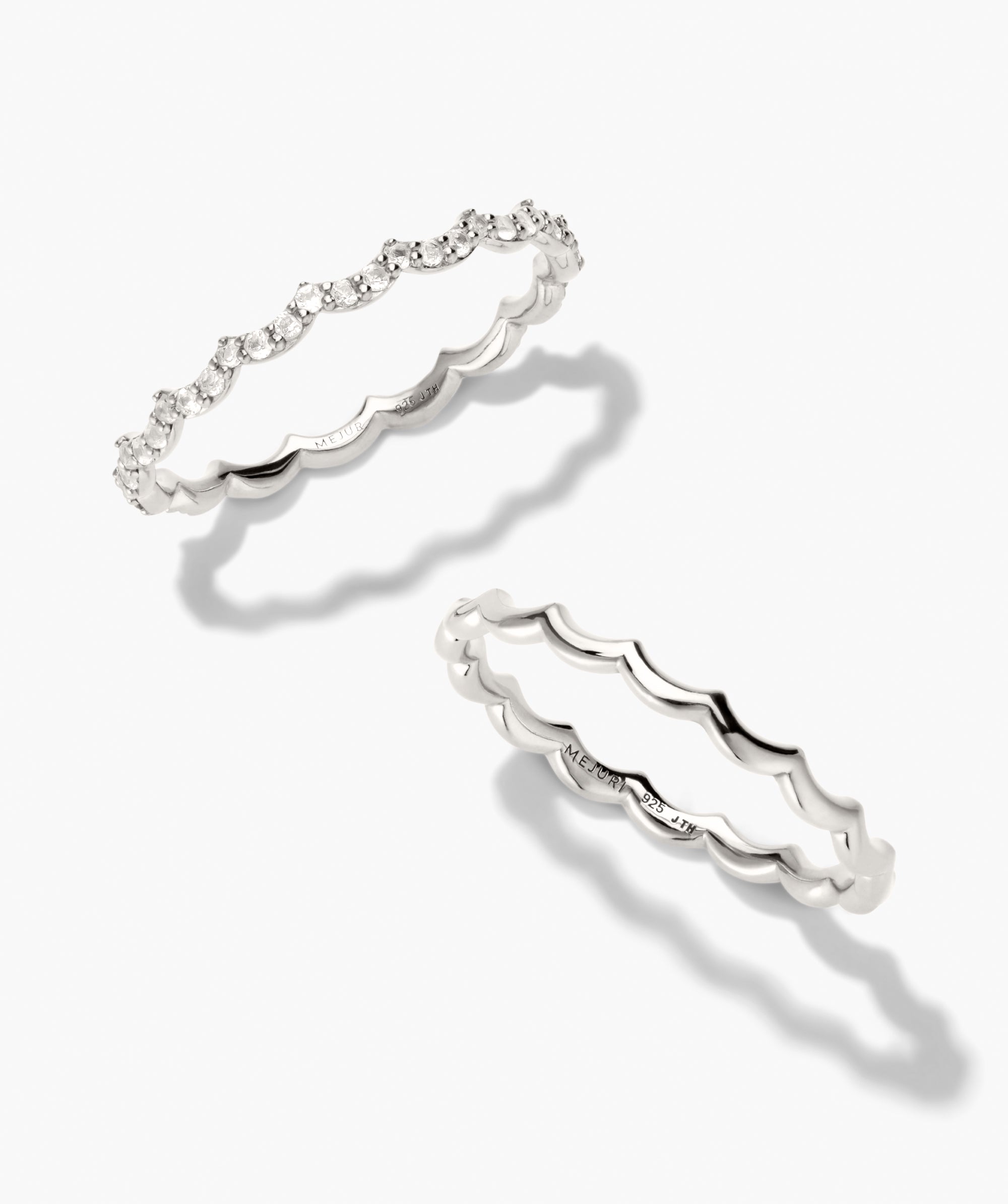 Slim Charlotte Stacker Set featuring two sterling silver scallop-edged rings; one with pavÃ©-set diamonds, the other plain, perfect for stylish stacking.