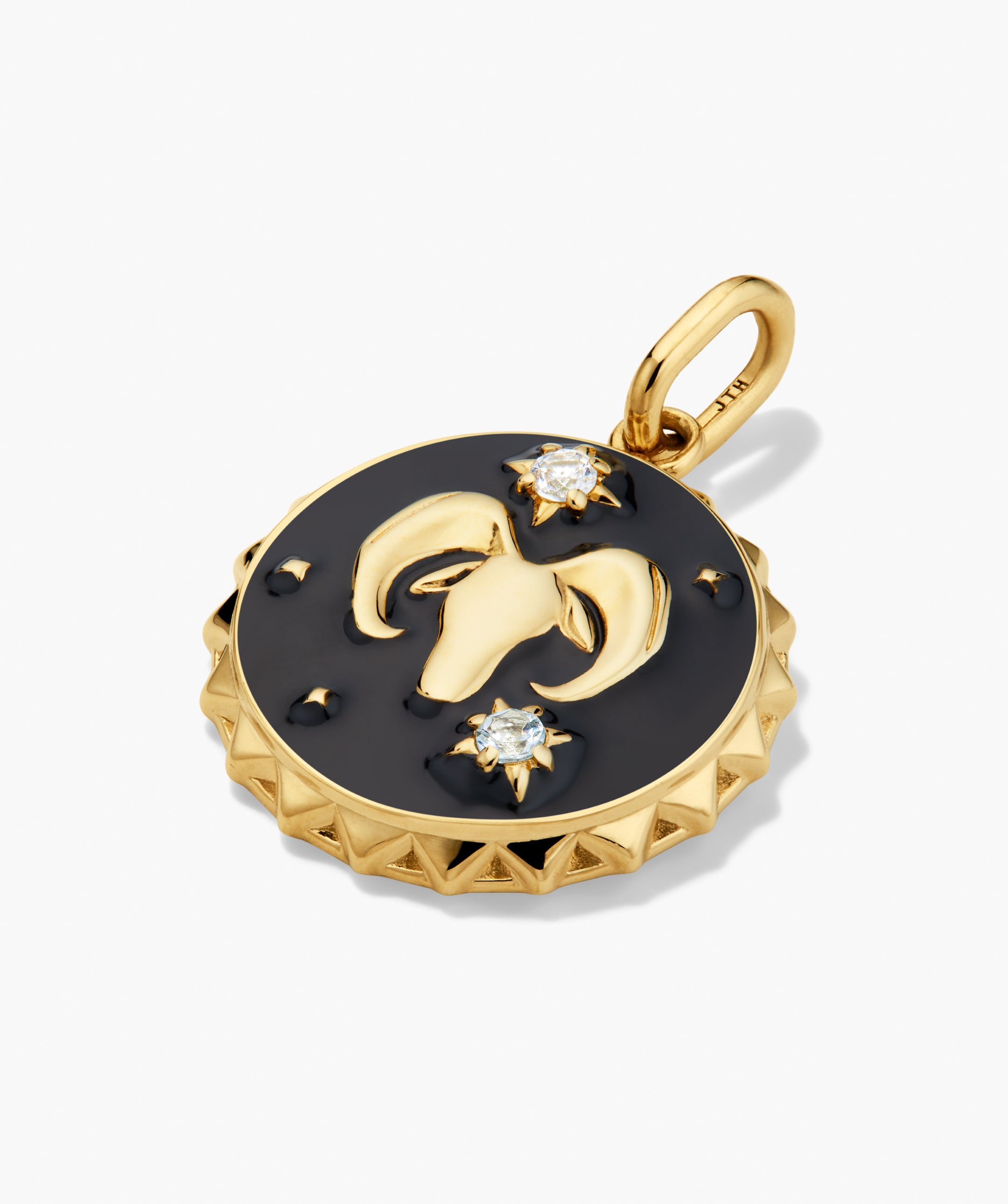 Cosmic Charm: A yellow gold medallion pendant with a black enamel background, featuring a ram's head relief and two starburst-set gemstones. Perfect for necklaces or bracelets.