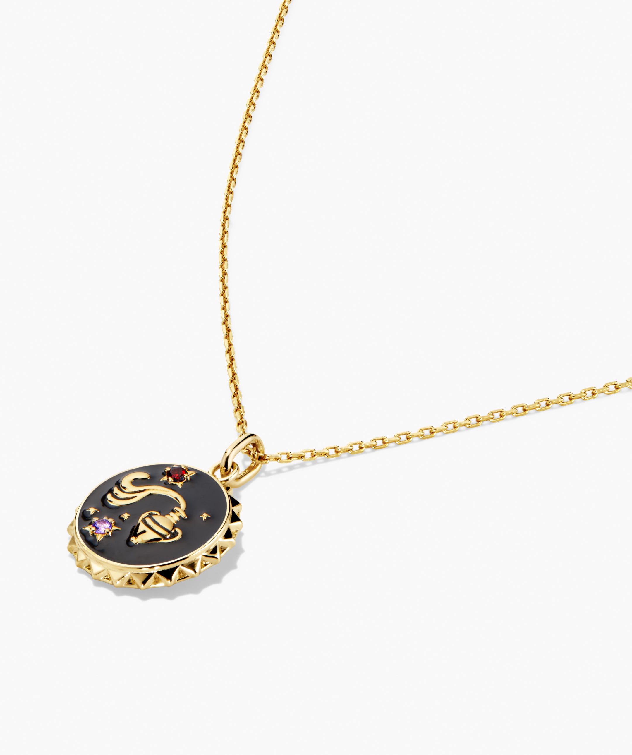 Cosmic Pendant Necklace featuring a fine gold chain with a round black enamel pendant, showcasing a gold scorpion motif accented by red and purple gemstones.