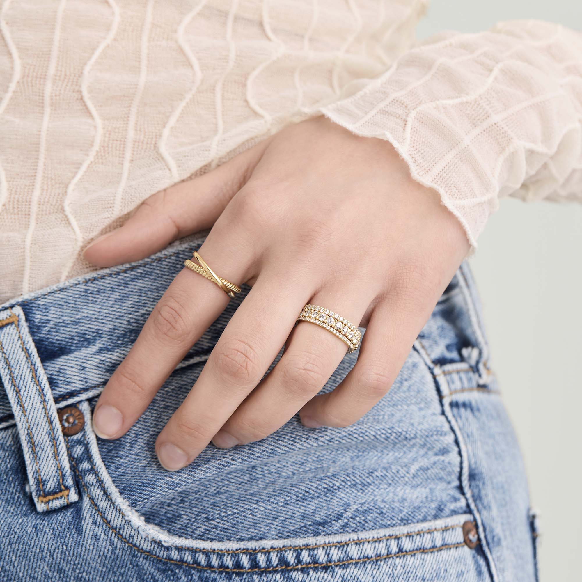 Diamond Eternity Band on a hand, featuring slim 14k solid gold with hand-set, responsibly sourced diamonds in open prongs for enhanced sparkle.