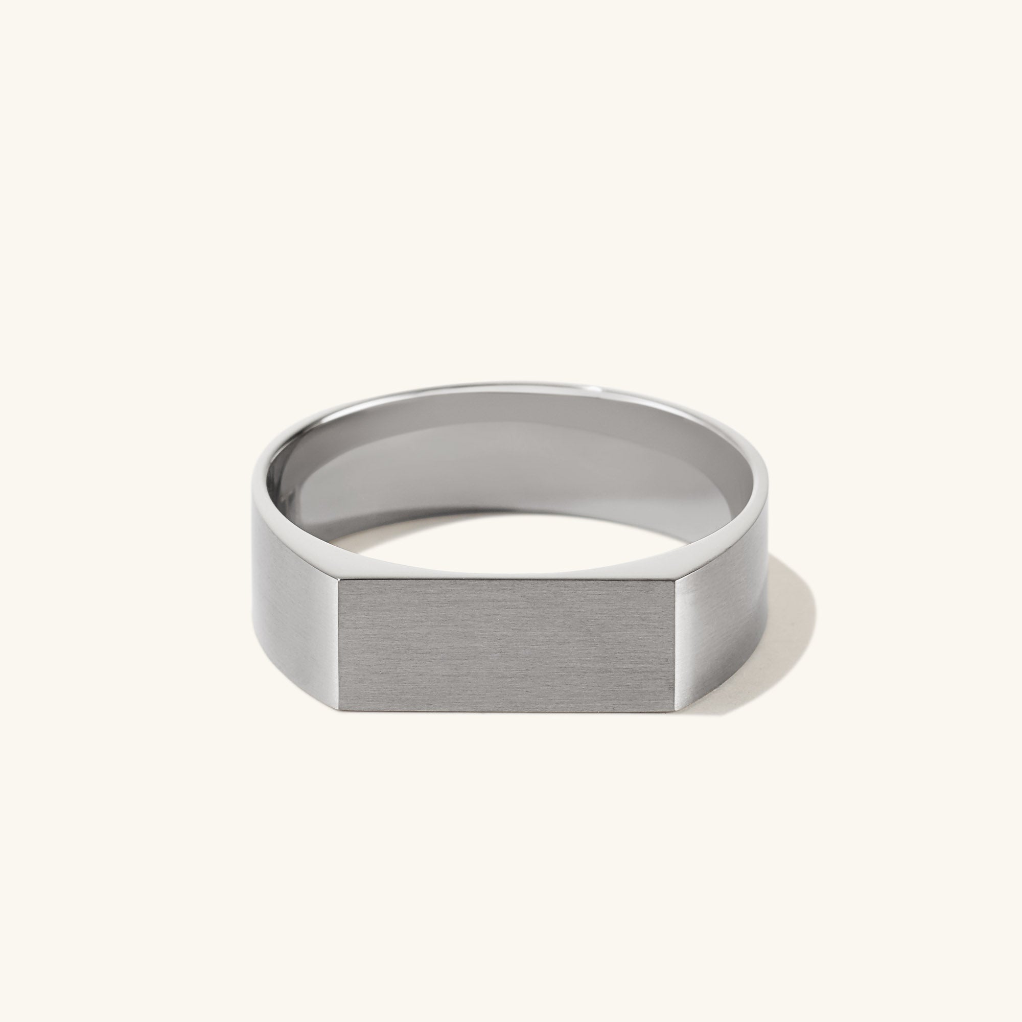 Slim Rectangular Signet Ring: A silver signet ring with a sleek, rectangular face, embodying bold style and substance.