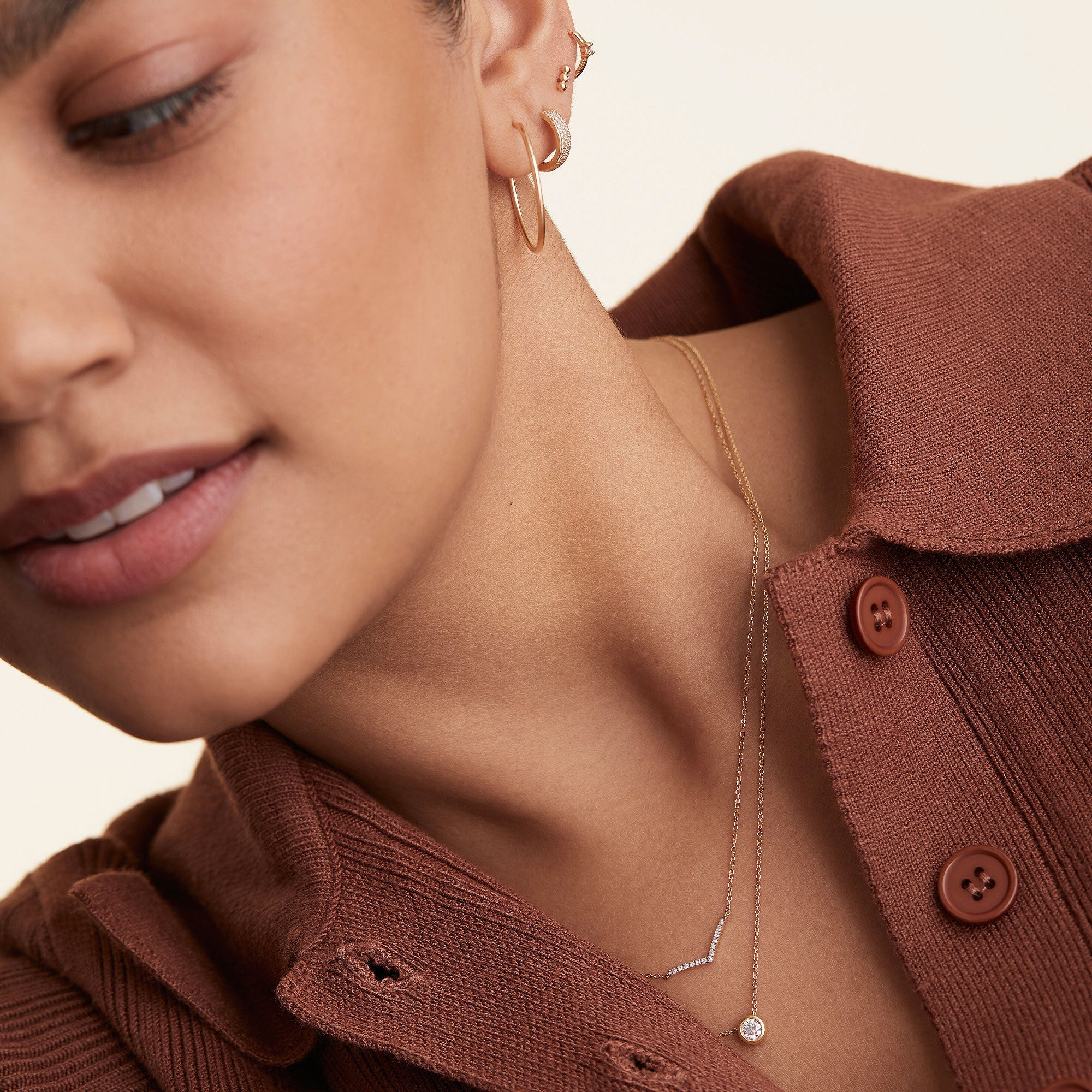 Woman wearing PavÃ© Diamond Wishbone Necklace, featuring 13 pavÃ© diamonds on a 14k gold cable chain, highlighting the elegant and delicate design.