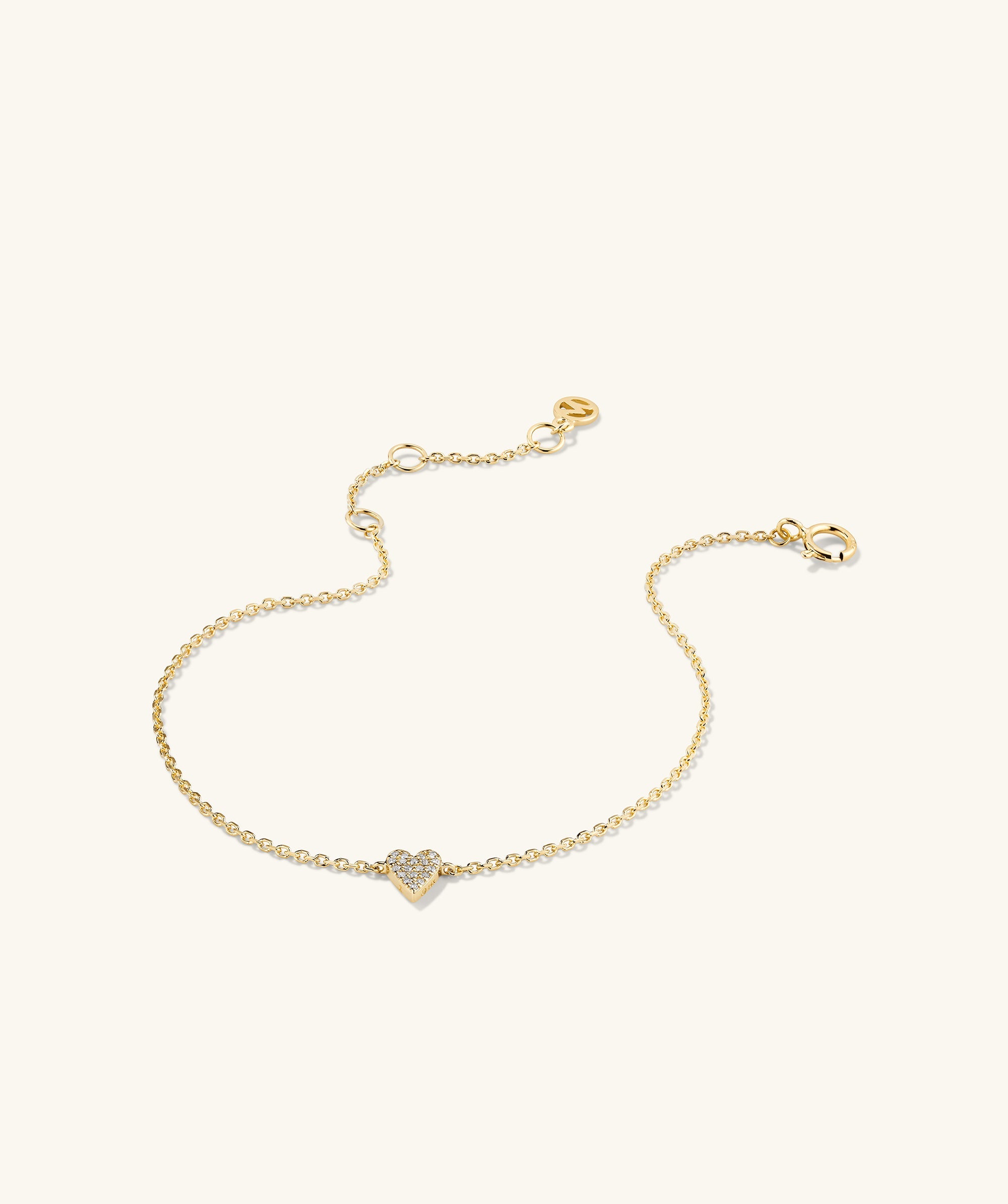 Mini Heart PavÃ© Diamond Bracelet featuring a gold chain with a heart-shaped pendant adorned with pavÃ© diamonds.