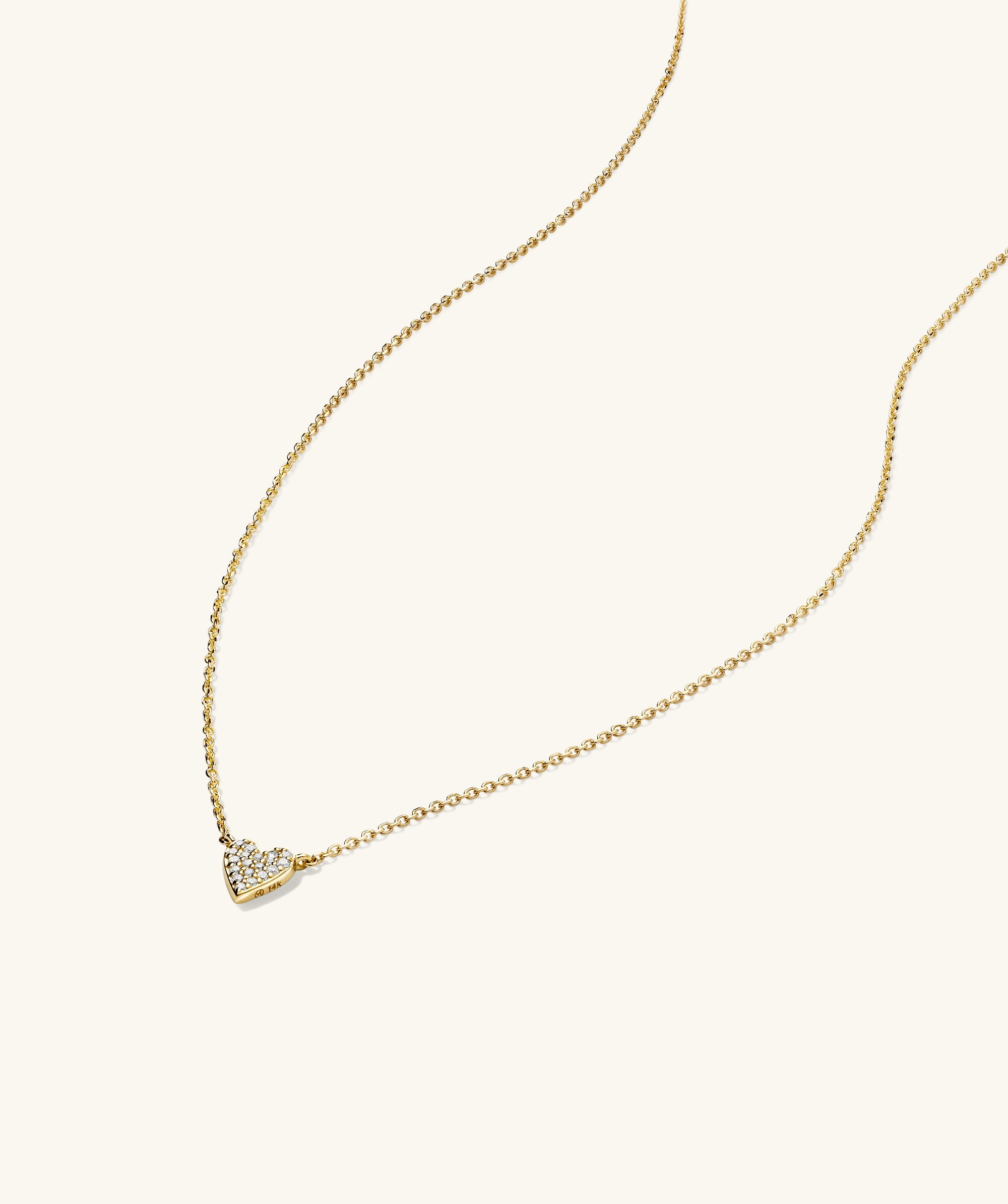 Mini Heart PavÃ© Diamond Necklace featuring a gold chain and heart-shaped pendant adorned with diamonds.