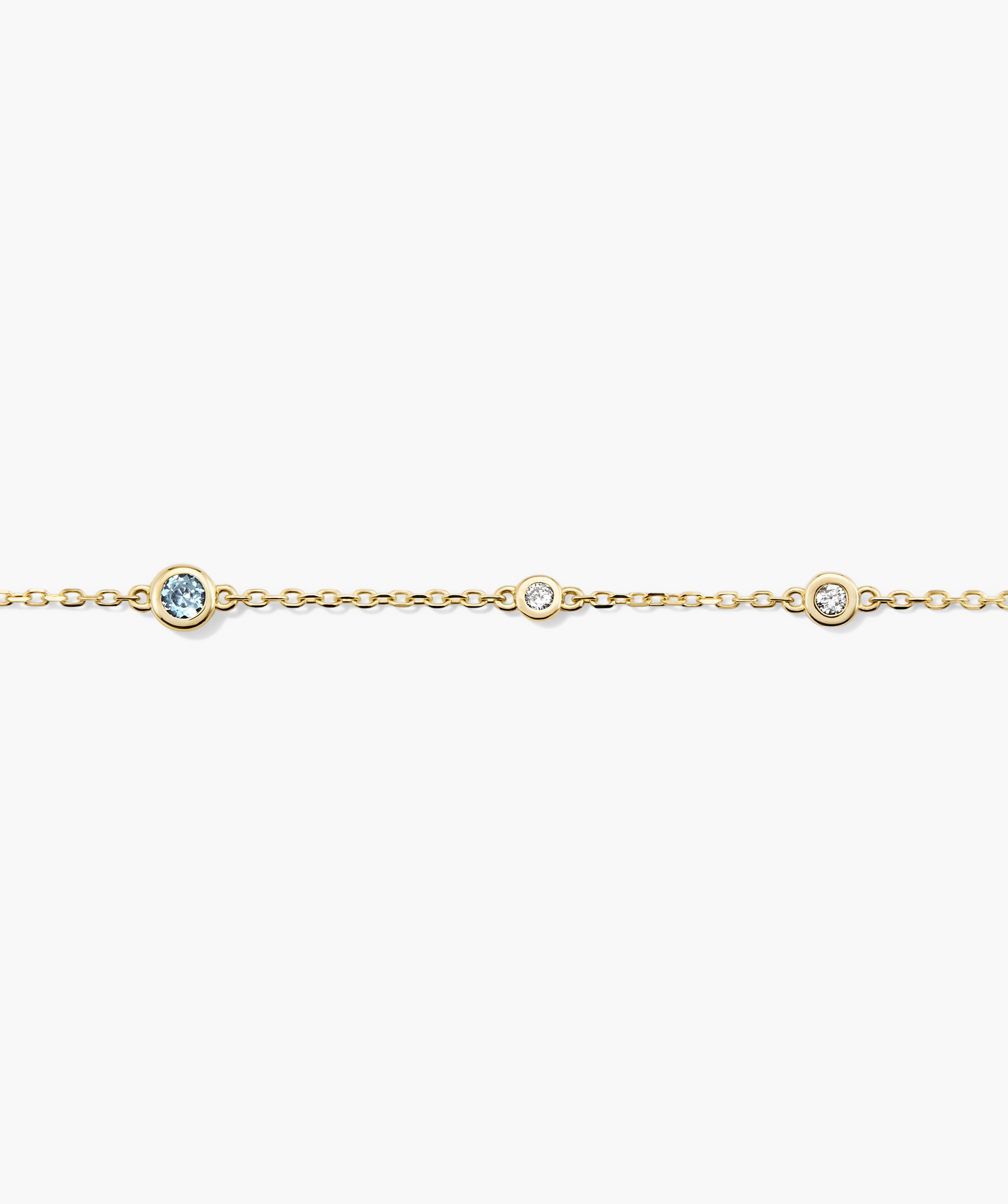 Multi Gemstone Station Bracelet featuring a 14k gold chain adorned with diamonds and a striking blue gemstone. Handcrafted for a sophisticated, stacked look.