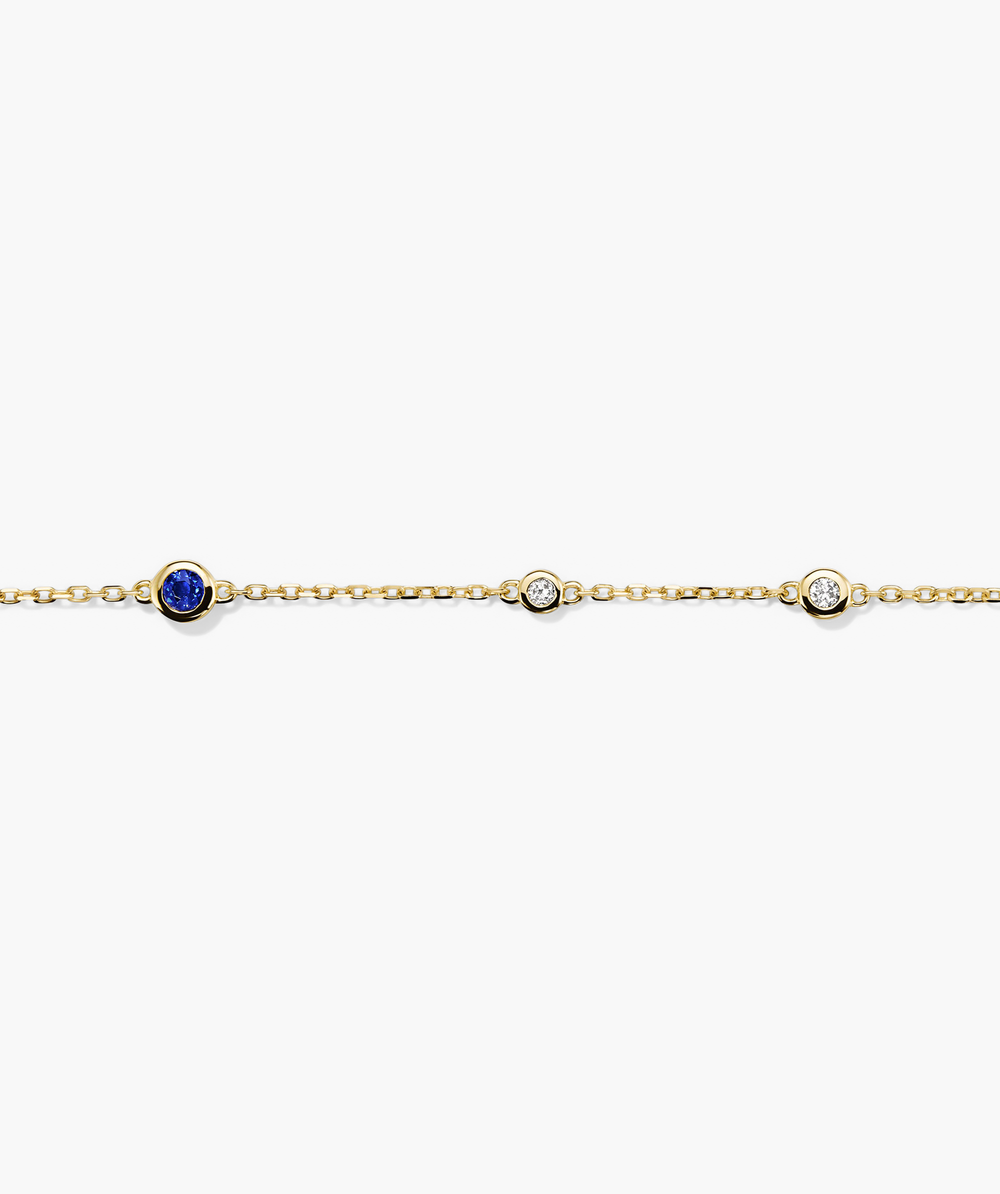 Multi Gemstone Station Bracelet: Handcrafted 14k gold chain adorned with diamonds and a central blue gemstone.