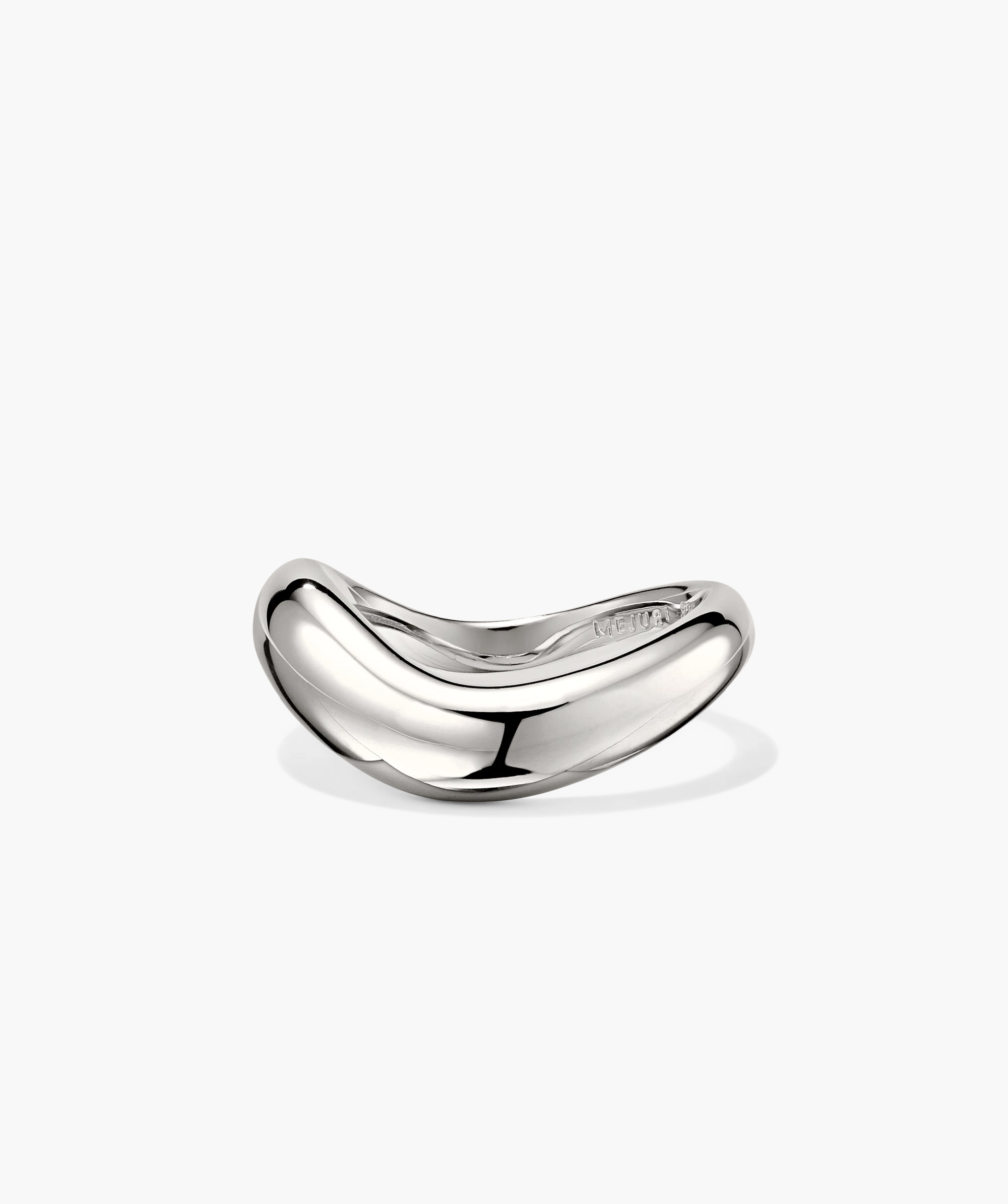 Close-up of the DÃ´me Figure Ring, a silver piece with smooth curves reflecting unique angles, inspired by slow, intentional movement.