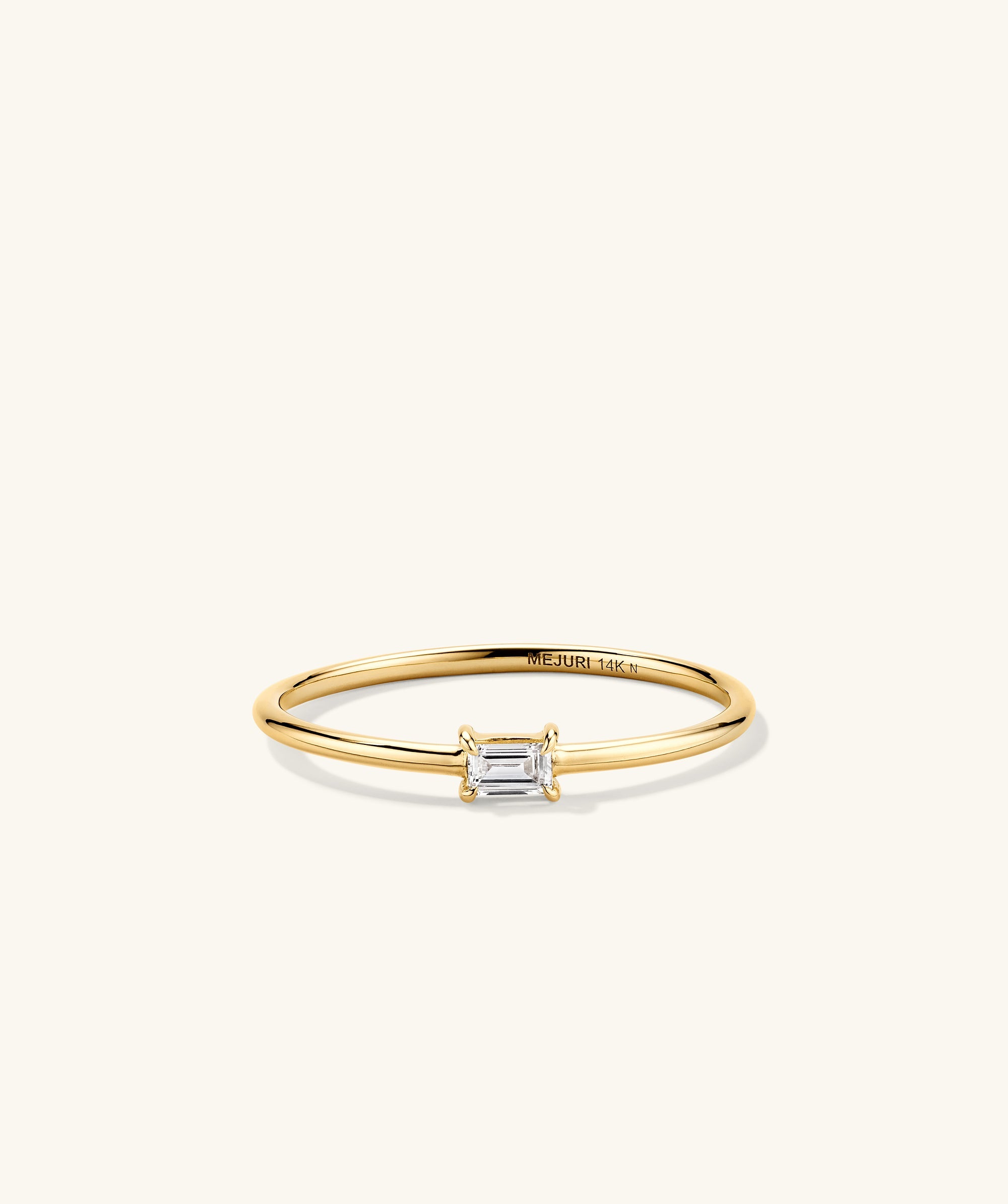 Baguette Stacker Ring: A gold ring featuring a prominent diamond baguette stone, perfect as an elegant fashion accessory or engagement ring.